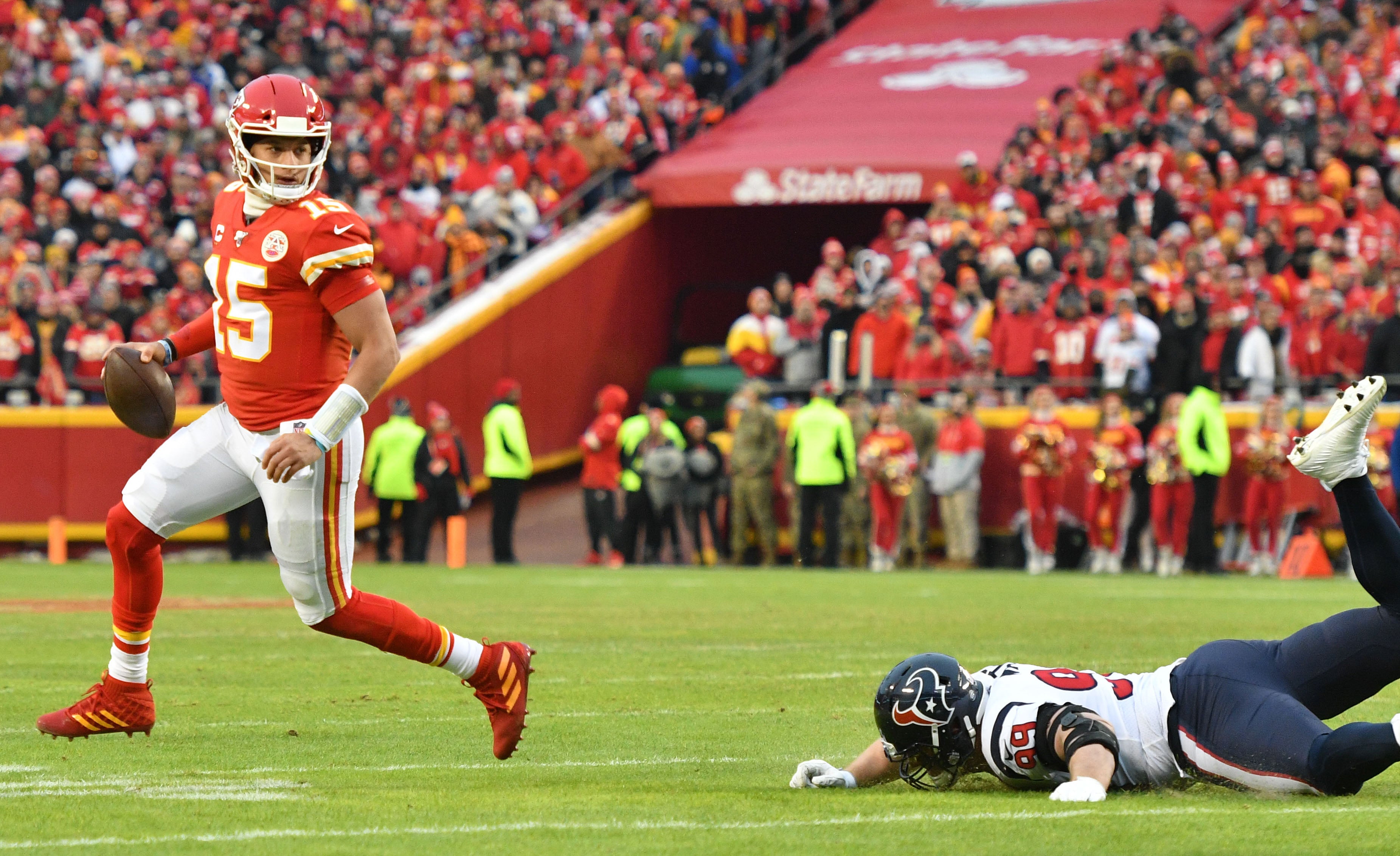 Jan 12, 2020; Kansas City, Missouri, USA; Kansas City Chiefs quarterback Patrick Mahomes (15) throws a pass as Houston Texans defensive end J.J. Watt (99) misses the tackle during the AFC Divisional Round playoff football game at Arrowhead Stadium.