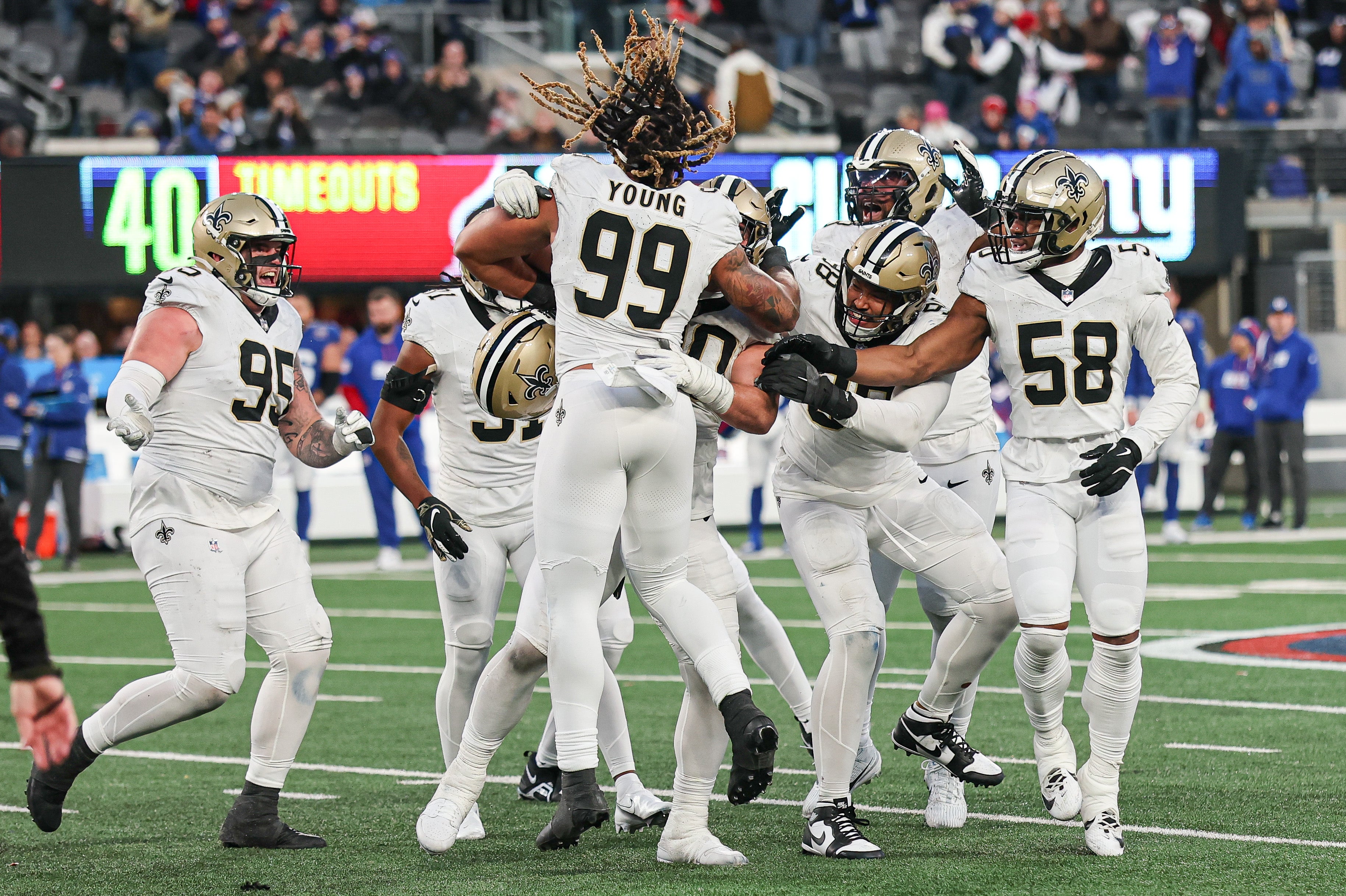 Dec 8, 2024; East Rutherford, New Jersey, USA; New Orleans Saints defensive tackle Bryan Bresee (90) celebrates with teammates after blocking a field goal during the fourth quarter by New York Giants place kicker Graham Gano (not pictured) at MetLife Stadium.