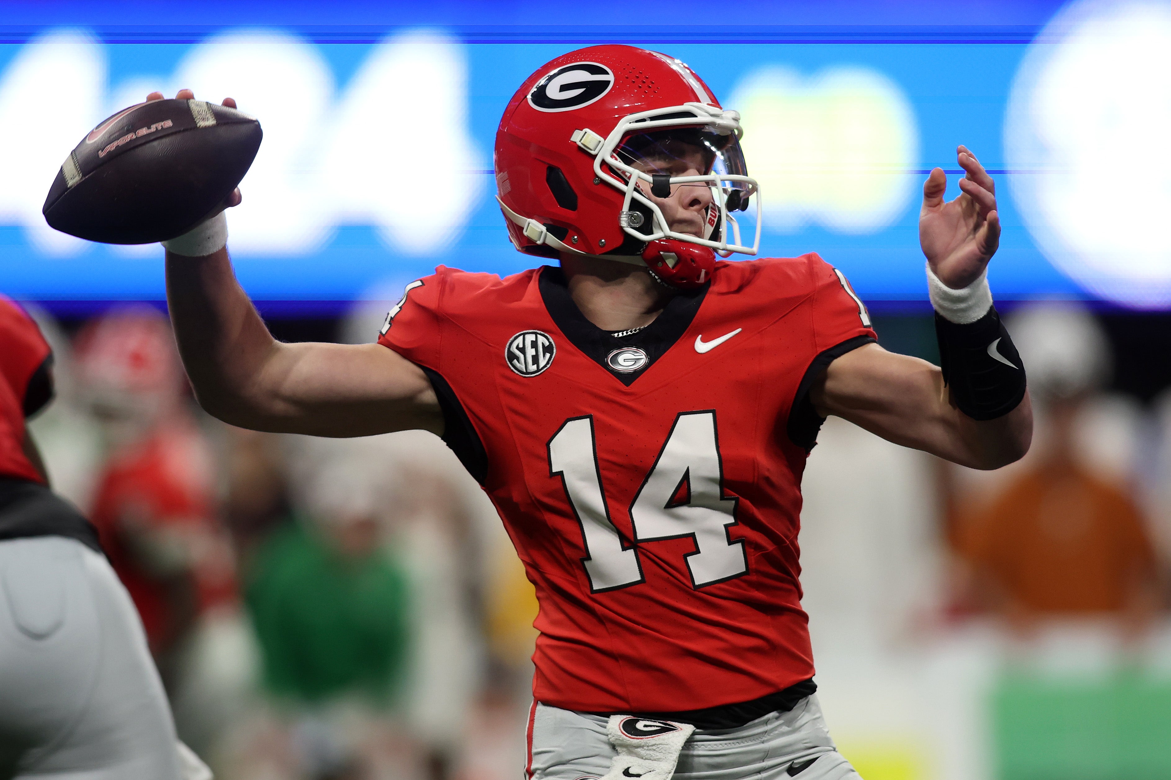 Georgia Bulldogs quarterback Gunner Stockton (14) drops back to pass against the Texas Longhorns during the second half in the 2024 SEC Championship game at Mercedes-Benz Stadium.