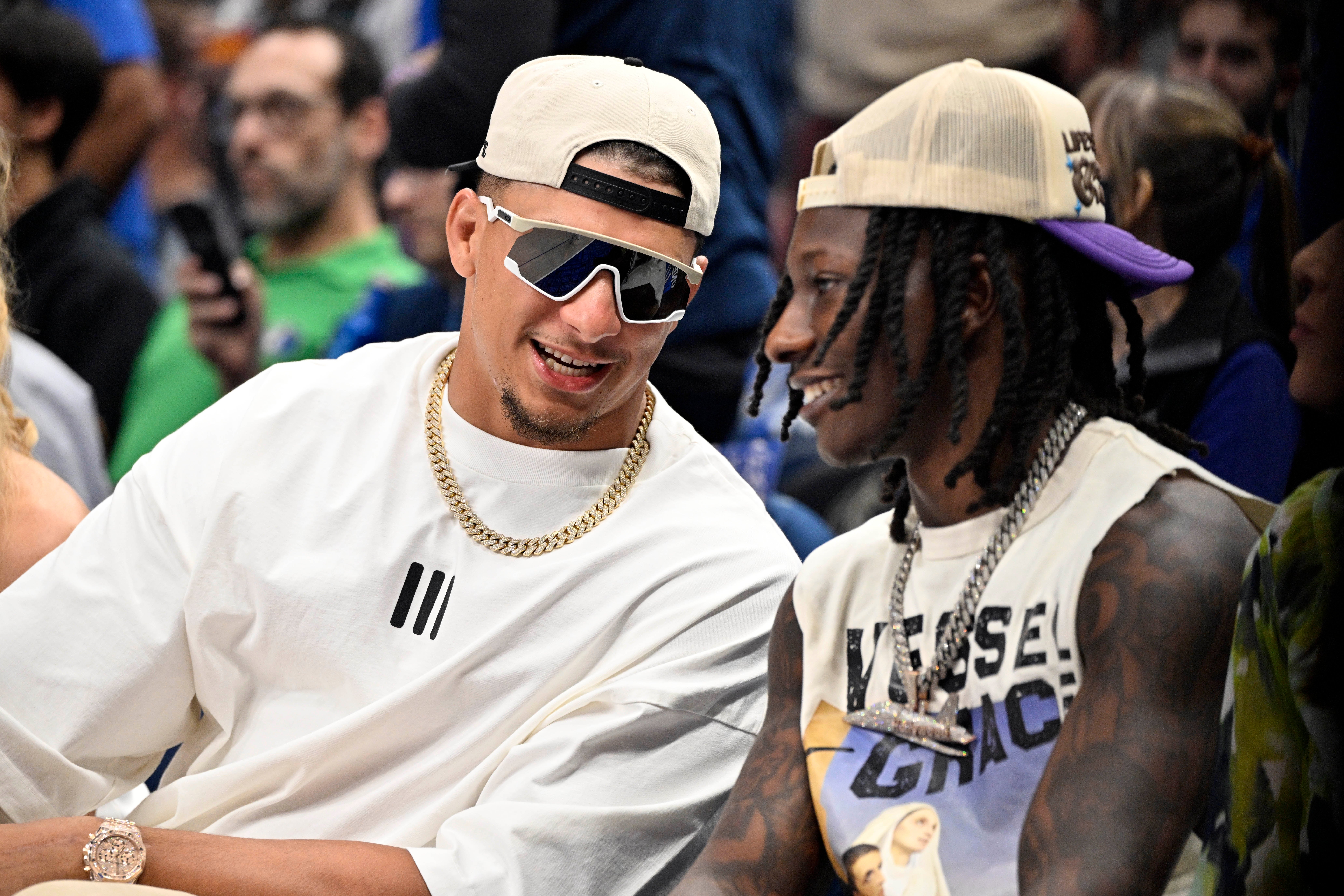 May 26, 2024; Dallas, Texas, USA; Kansas City Chiefs players Patrick Mahomes (left) and Hollywood Brown (right) look on in the first half between the Dallas Mavericks and the Minnesota Timberwolves during game three of the western conference finals for the 2024 NBA playoffs at American Airlines Center.