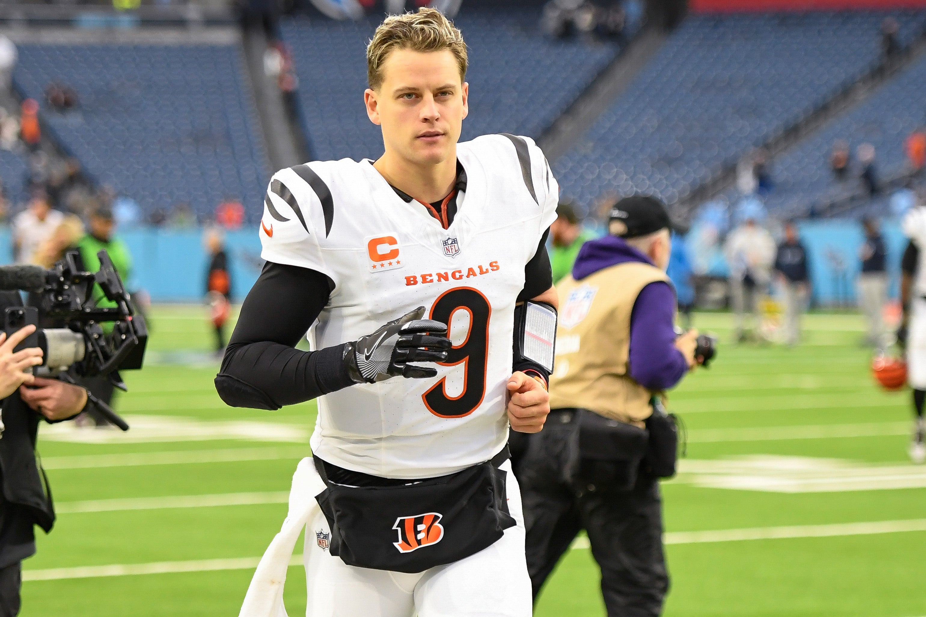 Dec 15, 2024; Nashville, Tennessee, USA; Cincinnati Bengals quarterback Joe Burrow (9) runs off the field against the Tennessee Titans during the second half at Nissan Stadium.