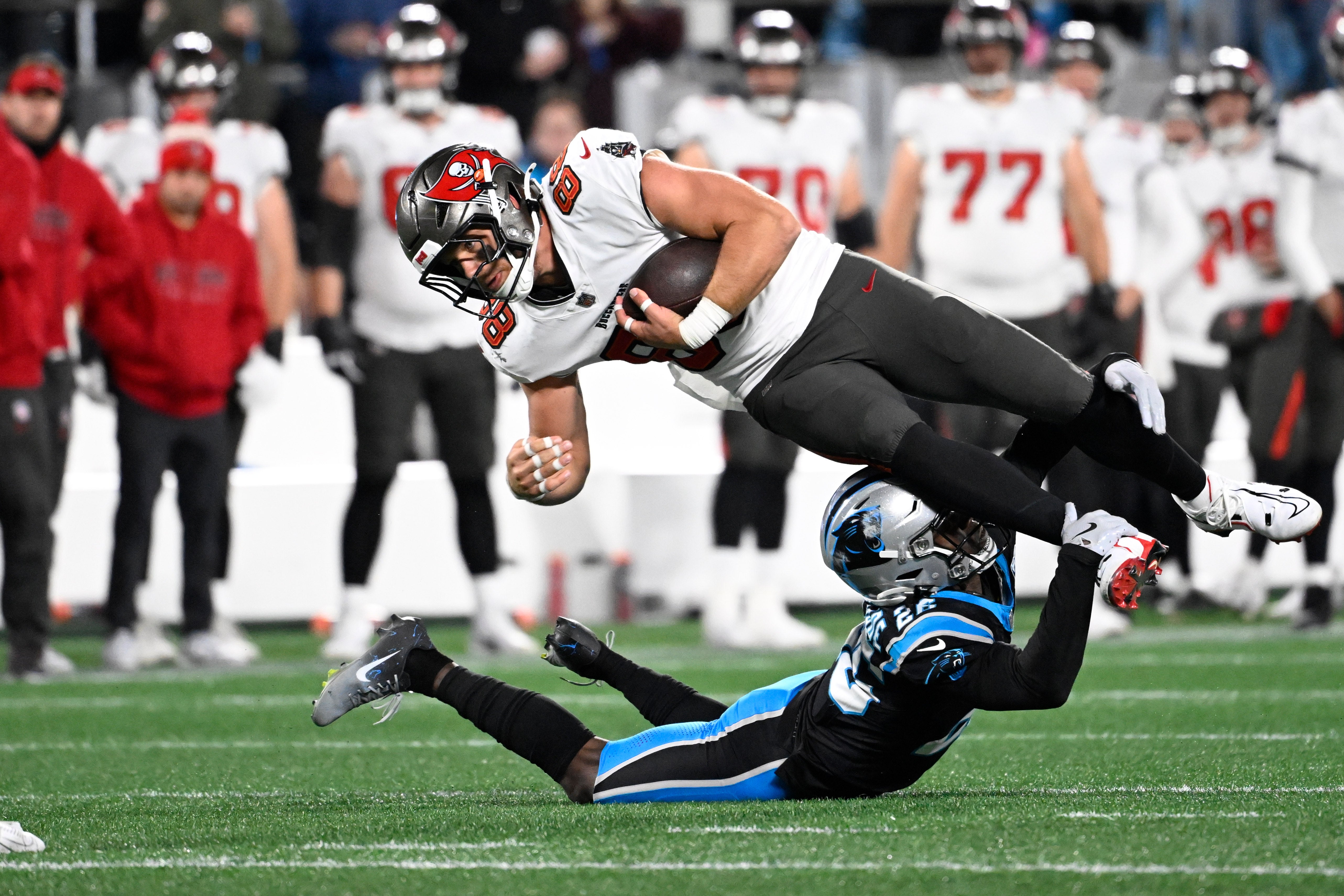 Dec 1, 2024; Charlotte, North Carolina, USA; Tampa Bay Buccaneers tight end Cade Otton (88) is tackled by Carolina Panthers cornerback Chau Smith-Wade (26) in overtime at Bank of America Stadium.
