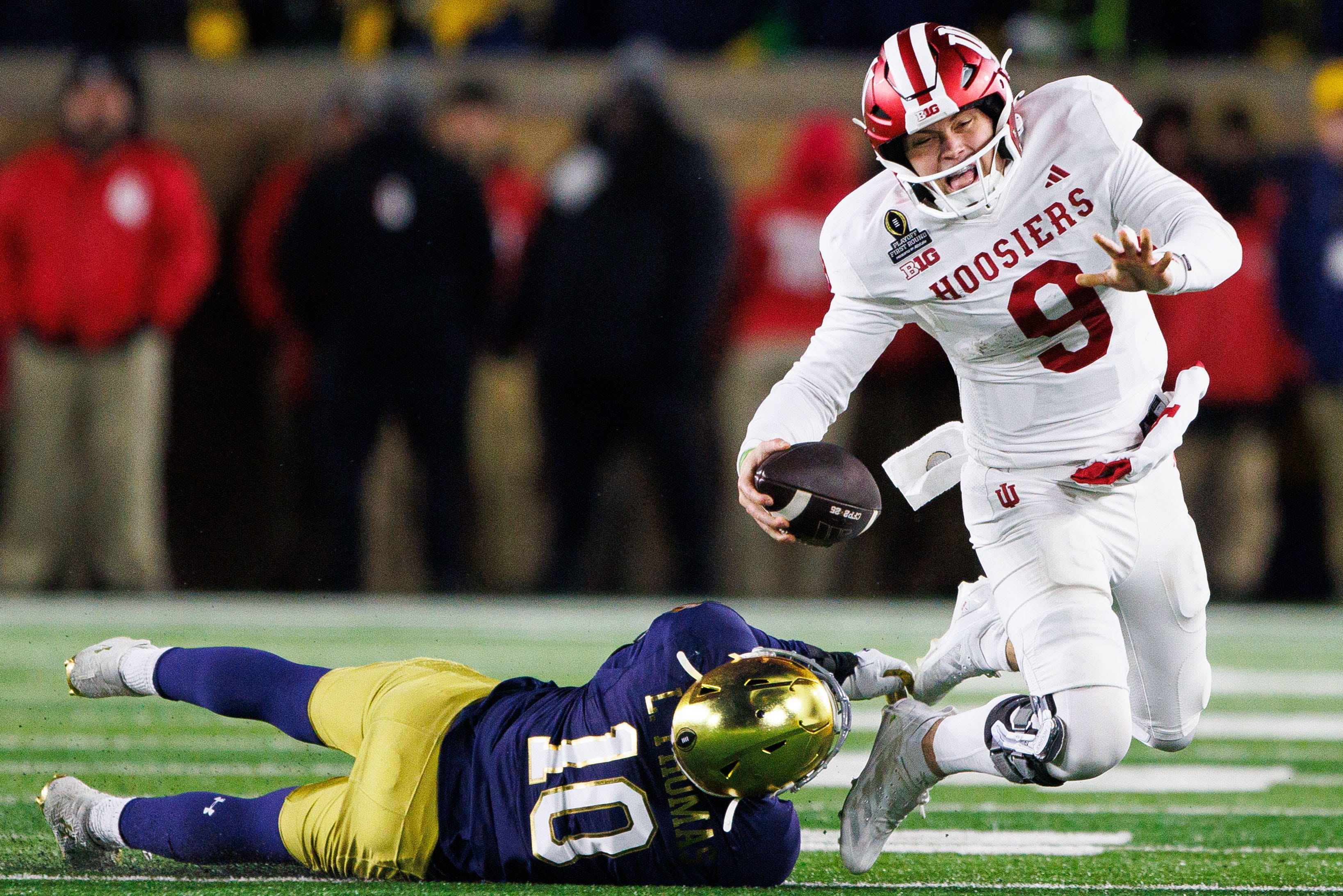 Notre Dame defensive lineman Loghan Thomas (10) tackles Indiana defensive back Jamier Johnson (9) during the first round of the College Football Playoff between Notre Dame and Indiana at Notre Dame Stadium on Friday, Dec. 20, 2024, in South Bend.