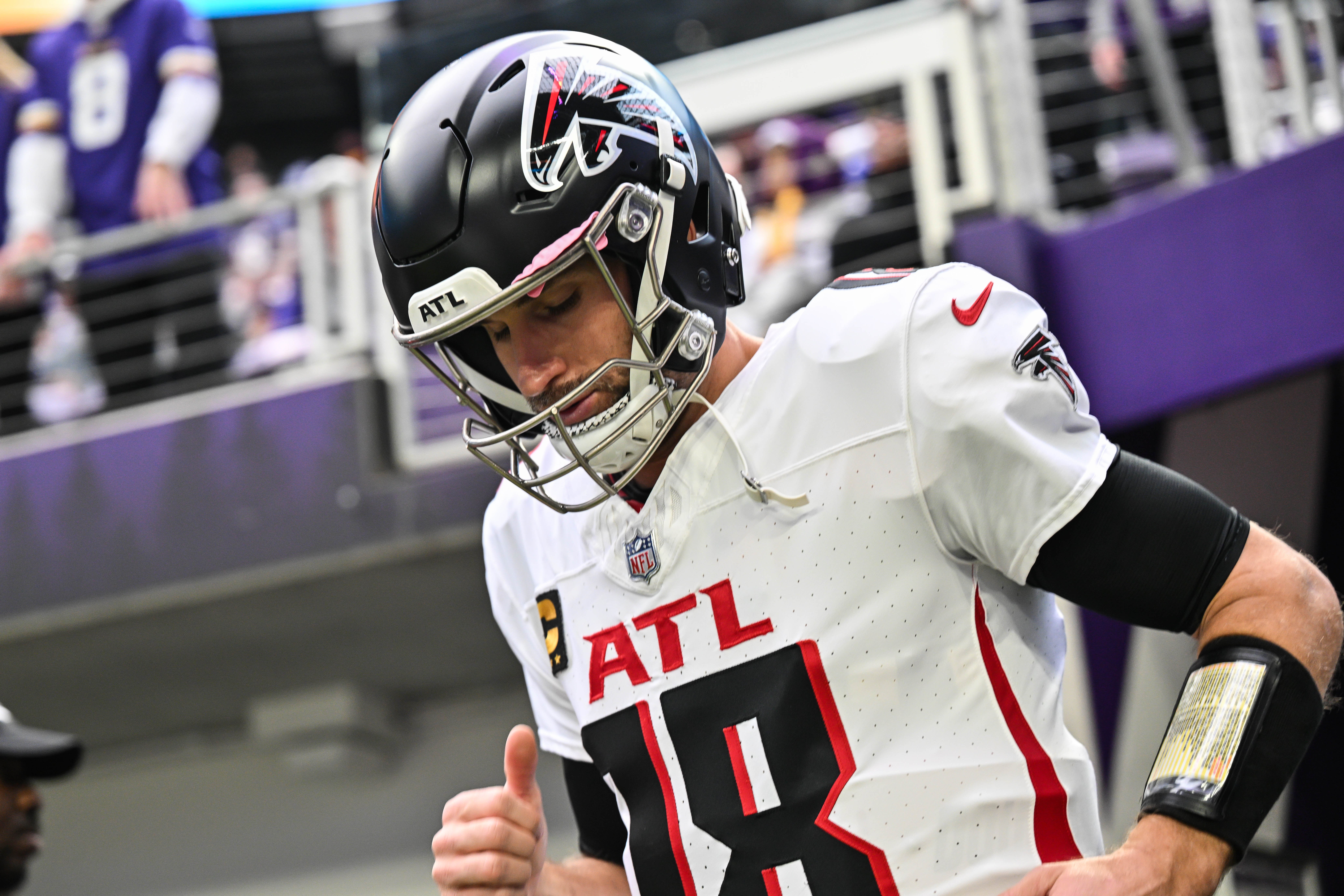 Atlanta Falcons quarterback Kirk Cousins (18) enters the field before the game against the Minnesota Vikings at U.S. Bank Stadium.
