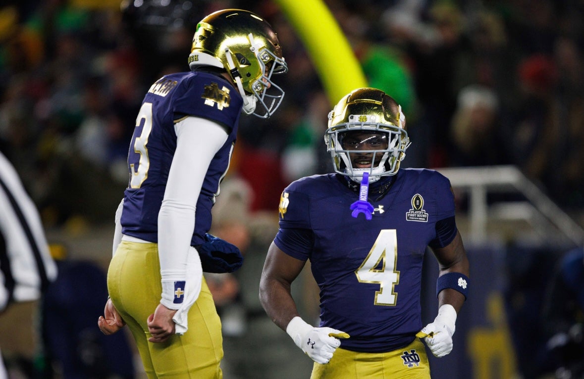 Notre Dame running back Jeremiyah Love (4) and quarterback Riley Leonard (13) celebrate a Love touchdown during the first round of the College Football Playoff