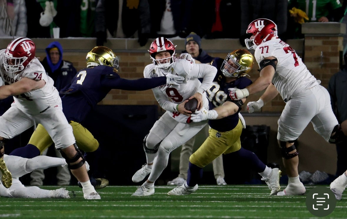 Dame Fighting Irish defensive lineman Rylie Mills (99) and linebacker Jaylen Sneed (3) sack Indiana Hoosiers quarterback Kurtis Rourke (9) during the second half at Notre Dame Stadium.
