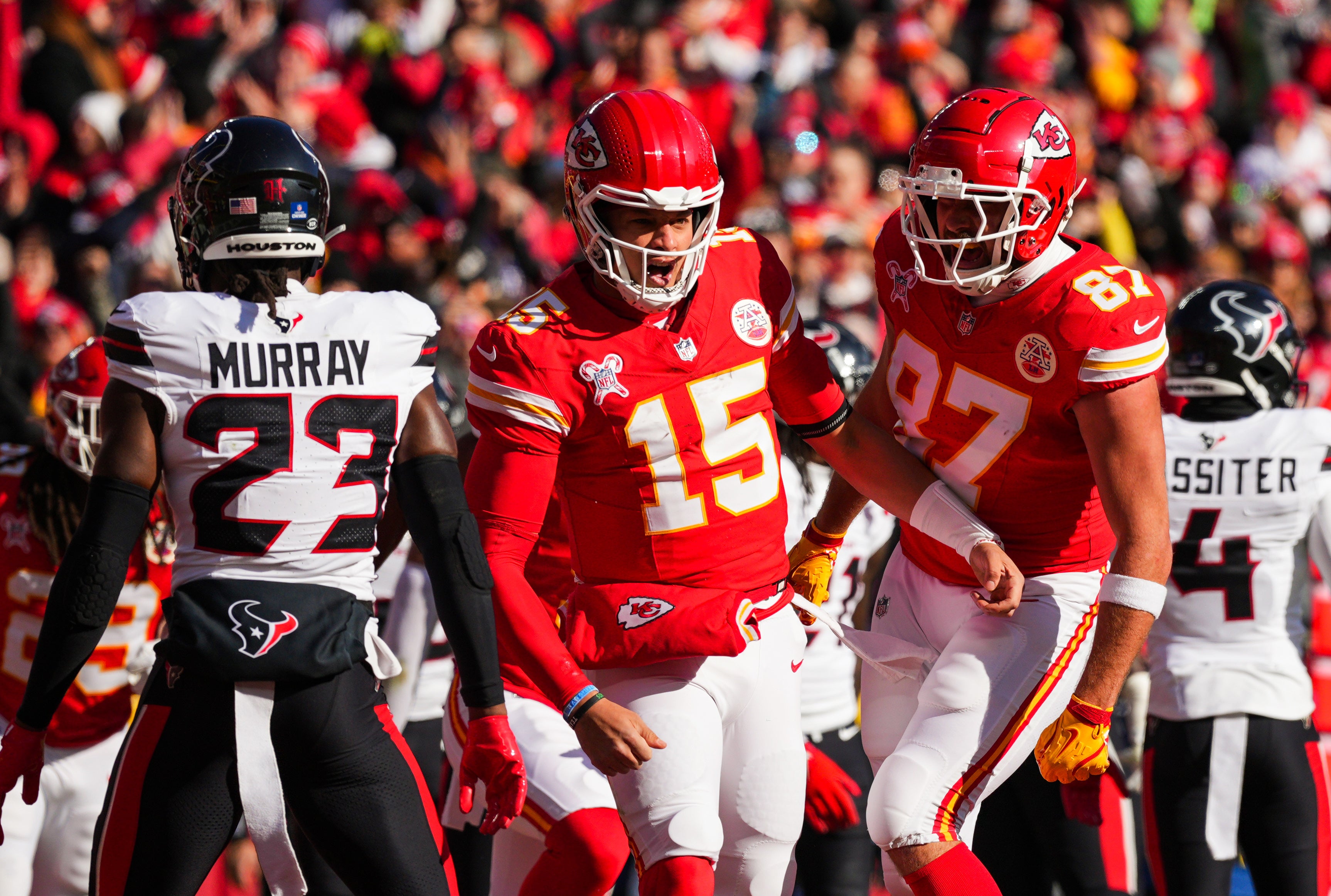 Dec 21, 2024; Kansas City, Missouri, USA; Kansas City Chiefs quarterback Patrick Mahomes (15) celebrates with tight end Travis Kelce (87) after scoring a touchdown during the first half against the Houston Texans at GEHA Field at Arrowhead Stadium.