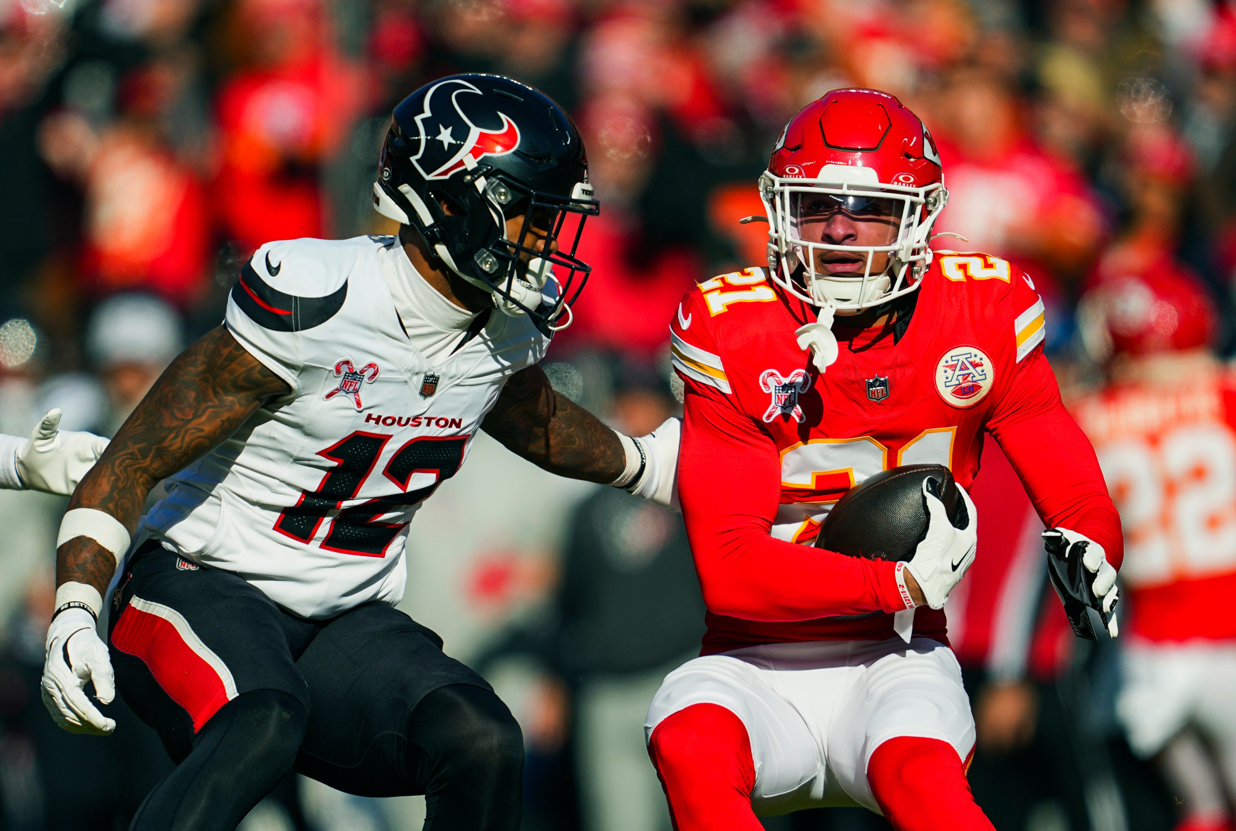 Dec 21, 2024; Kansas City, Missouri, USA; Kansas City Chiefs safety Jaden Hicks (21) intercepts a pass intended for Houston Texans wide receiver Nico Collins (12) during the first half at GEHA Field at Arrowhead Stadium.