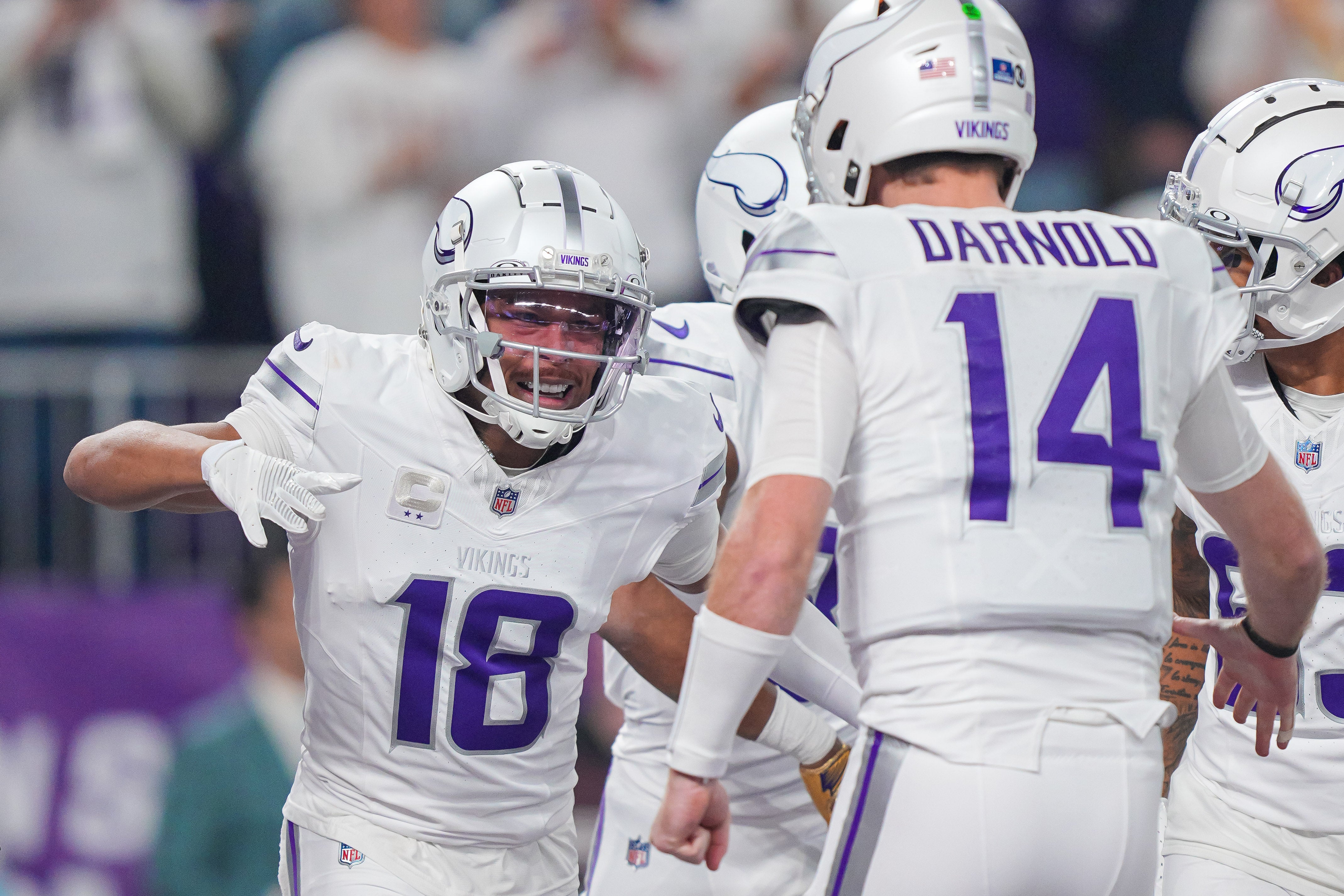 Dec 16, 2024; Minneapolis, Minnesota, USA; Minnesota Vikings wide receiver Justin Jefferson (18) celebrates his touchdown with quarterback Sam Darnold (14) against the Chicago Bears in the first quarter at U.S. Bank Stadium.