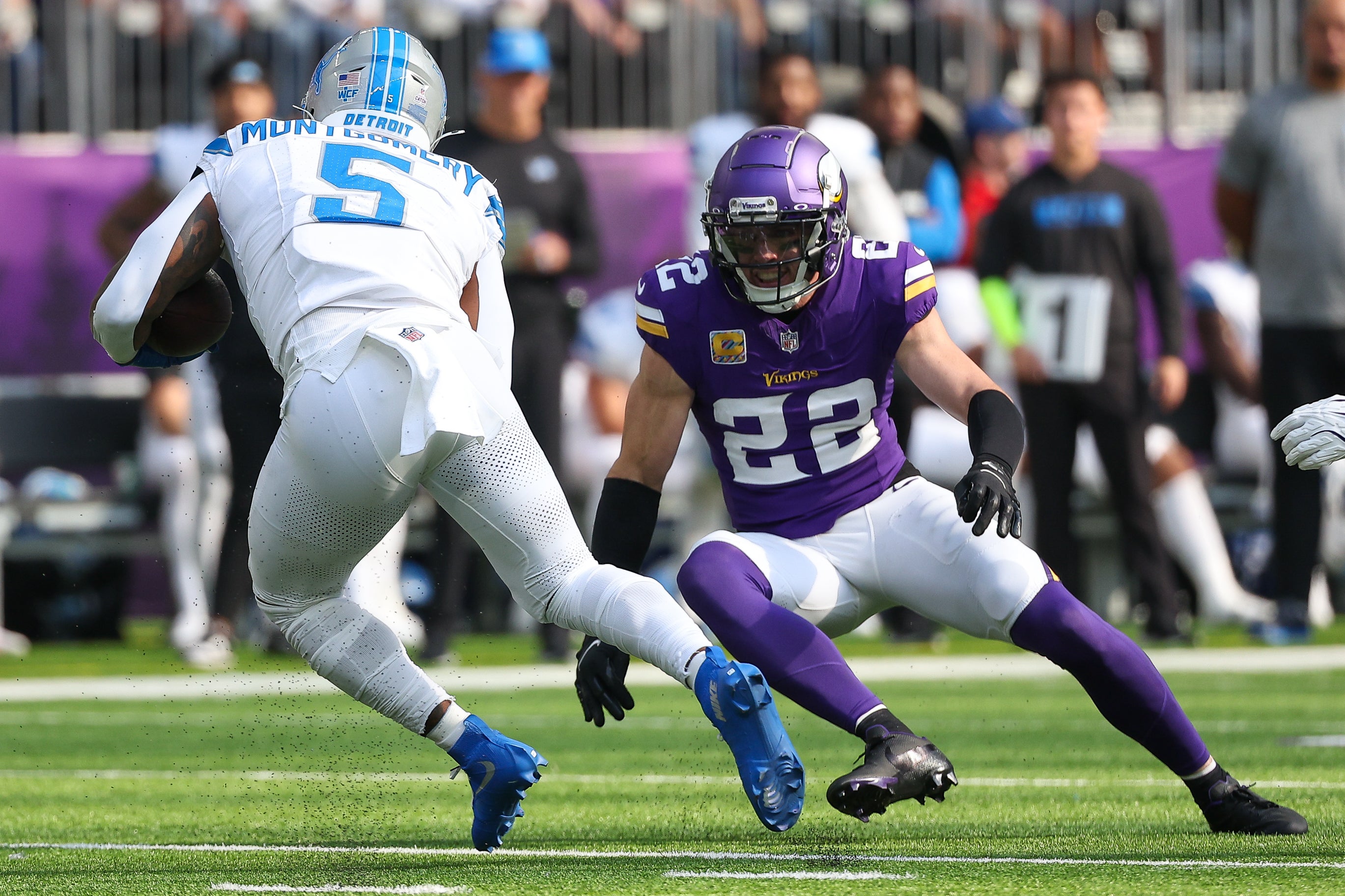 Oct 20, 2024; Minneapolis, Minnesota, USA; Detroit Lions running back David Montgomery (5) runs the ball as Minnesota Vikings safety Harrison Smith (22) defends during the first quarter at U.S. Bank Stadium.