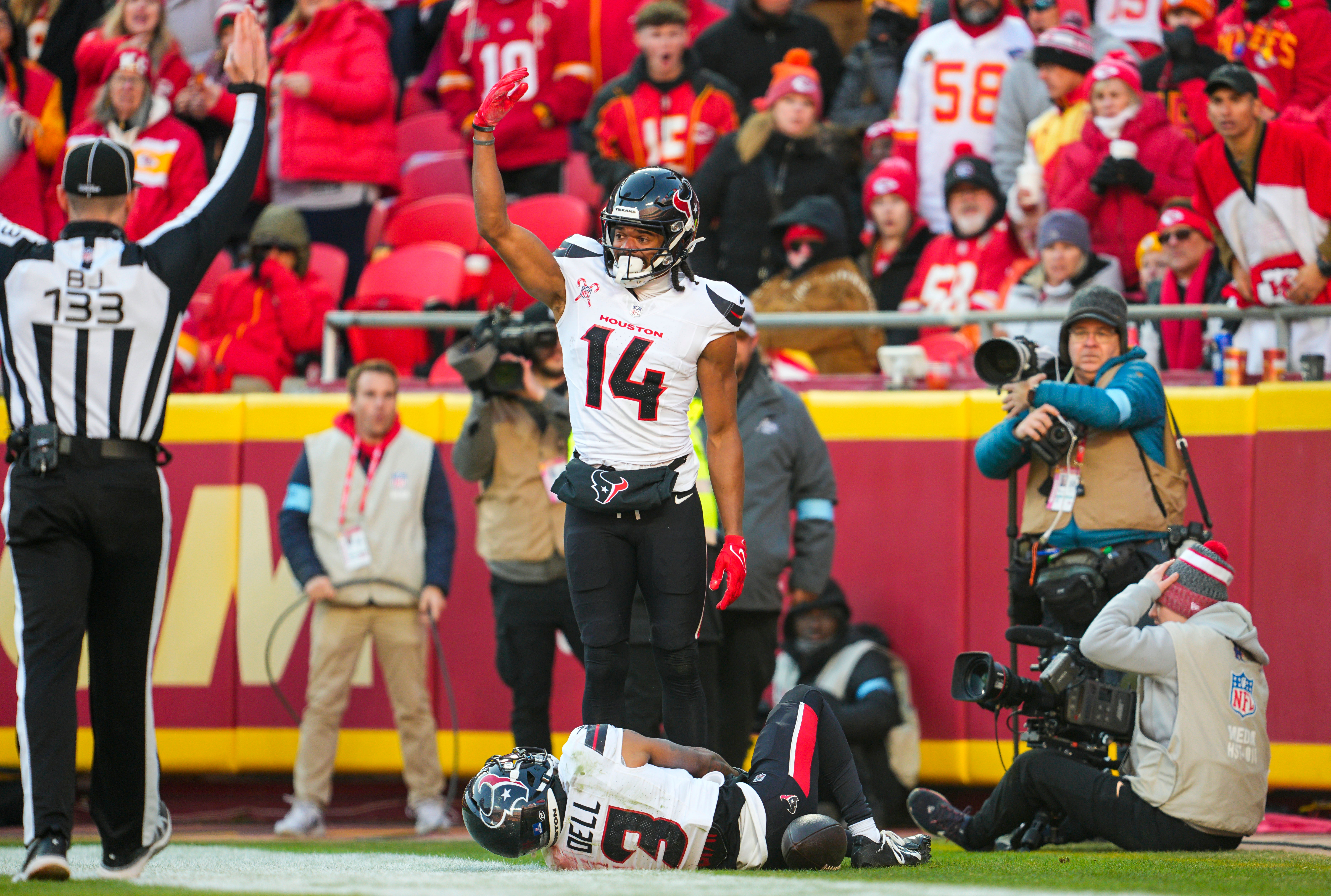 Dec 21, 2024; Kansas City, Missouri, USA; Houston Texans wide receiver Jared Wayne (14) calls for medical staff after an injury to wide receiver Tank Dell (3) during the second half against the Kansas City Chiefs at GEHA Field at Arrowhead Stadium.