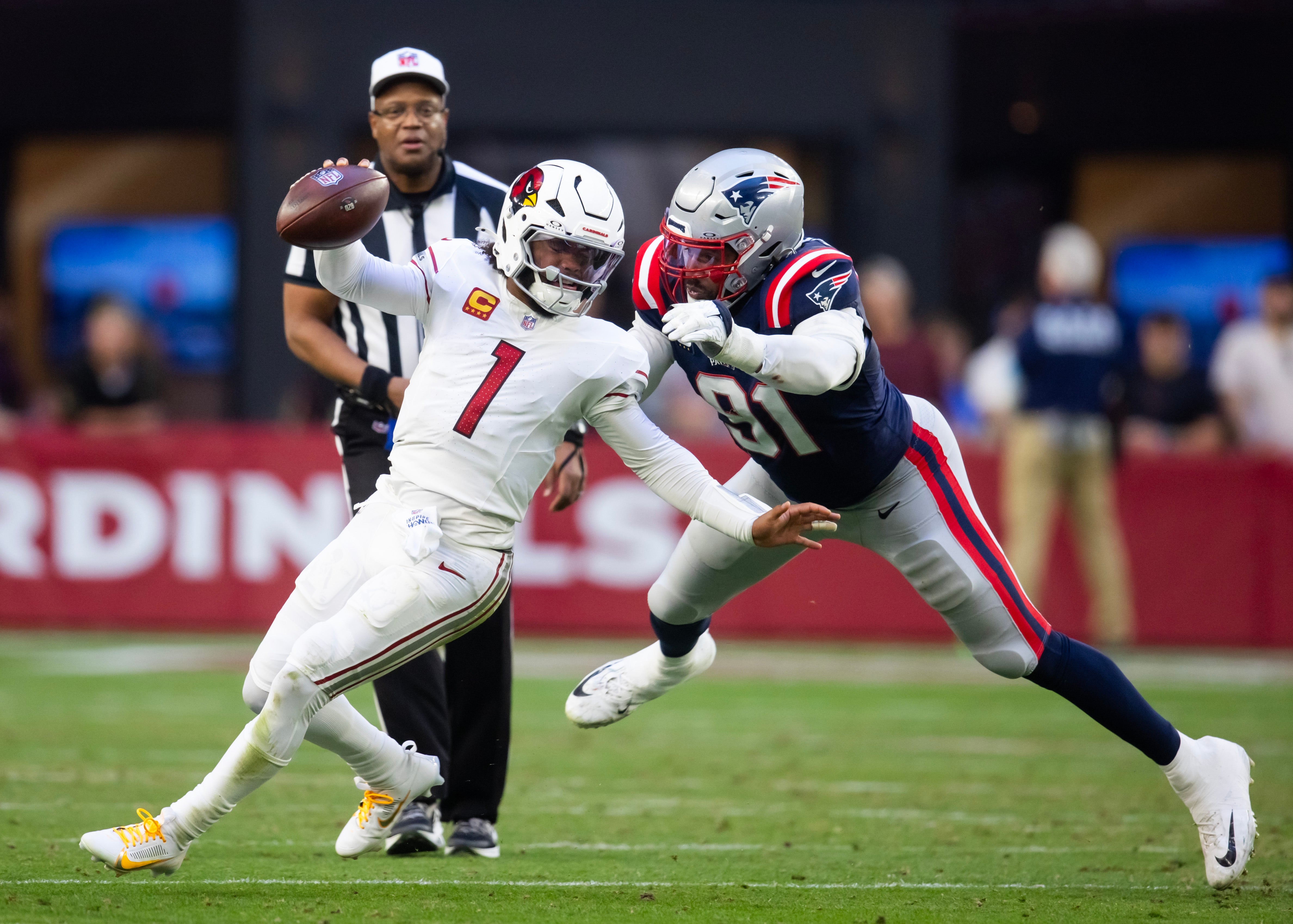 Dec 15, 2024; Glendale, Arizona, USA; New England Patriots defensive end Deatrich Wise Jr. (91) commits a horse collar tackle on Arizona Cardinals quarterback Kyler Murray (1) in the second half at State Farm Stadium.