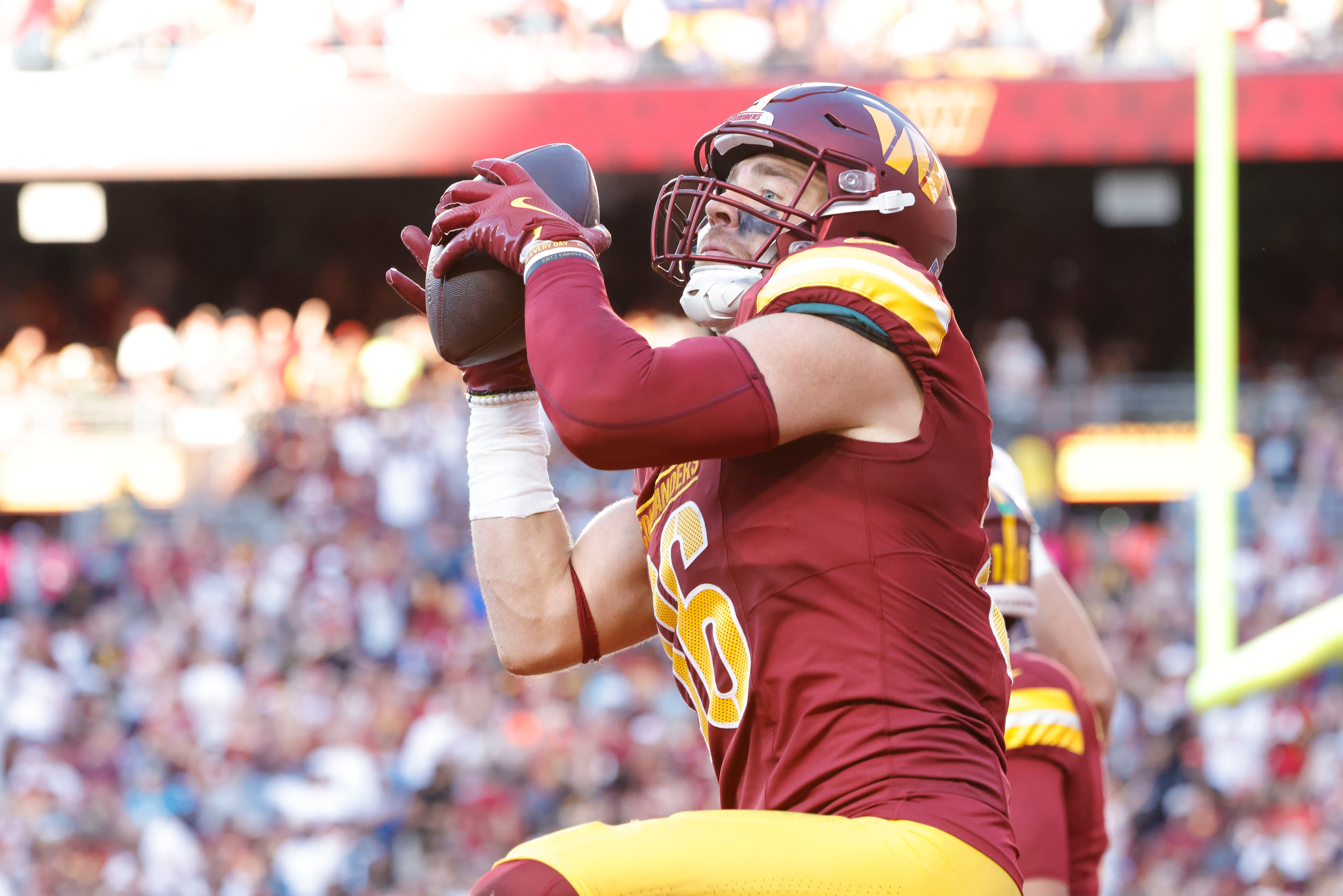 Oct 20, 2024; Landover, Maryland, USA; Washington Commanders tight end Zach Ertz (86) celebrates with fans in the stands after scoring a touchdown during the second quarter against the Carolina Panthers at Northwest Stadium. Mandatory Credit: Amber Searls-Imagn Images