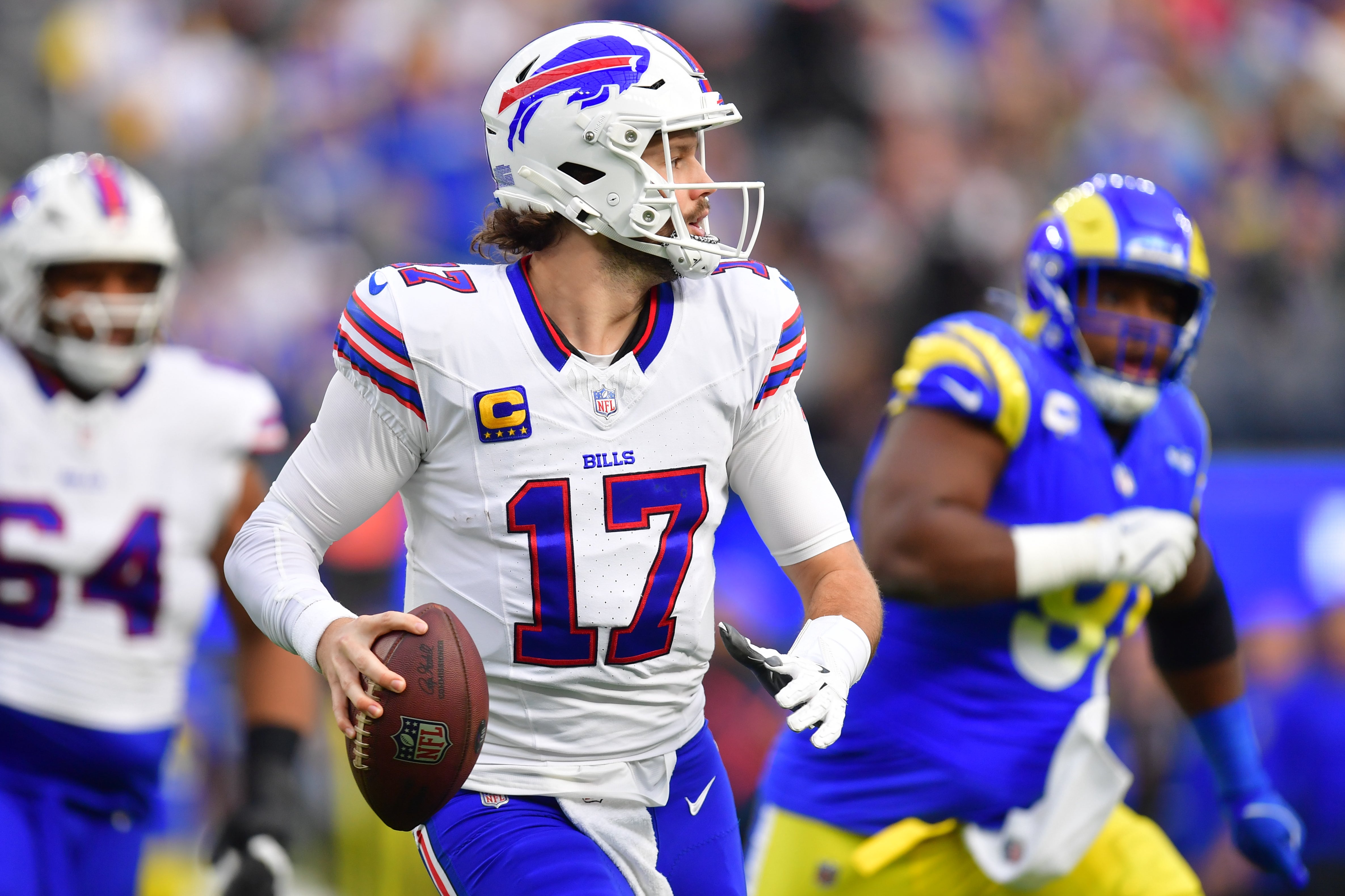 Dec 8, 2024; Inglewood, California, USA; Buffalo Bills quarterback Josh Allen (17) runs the ball against the against the Los Angeles Rams during the first half at SoFi Stadium.