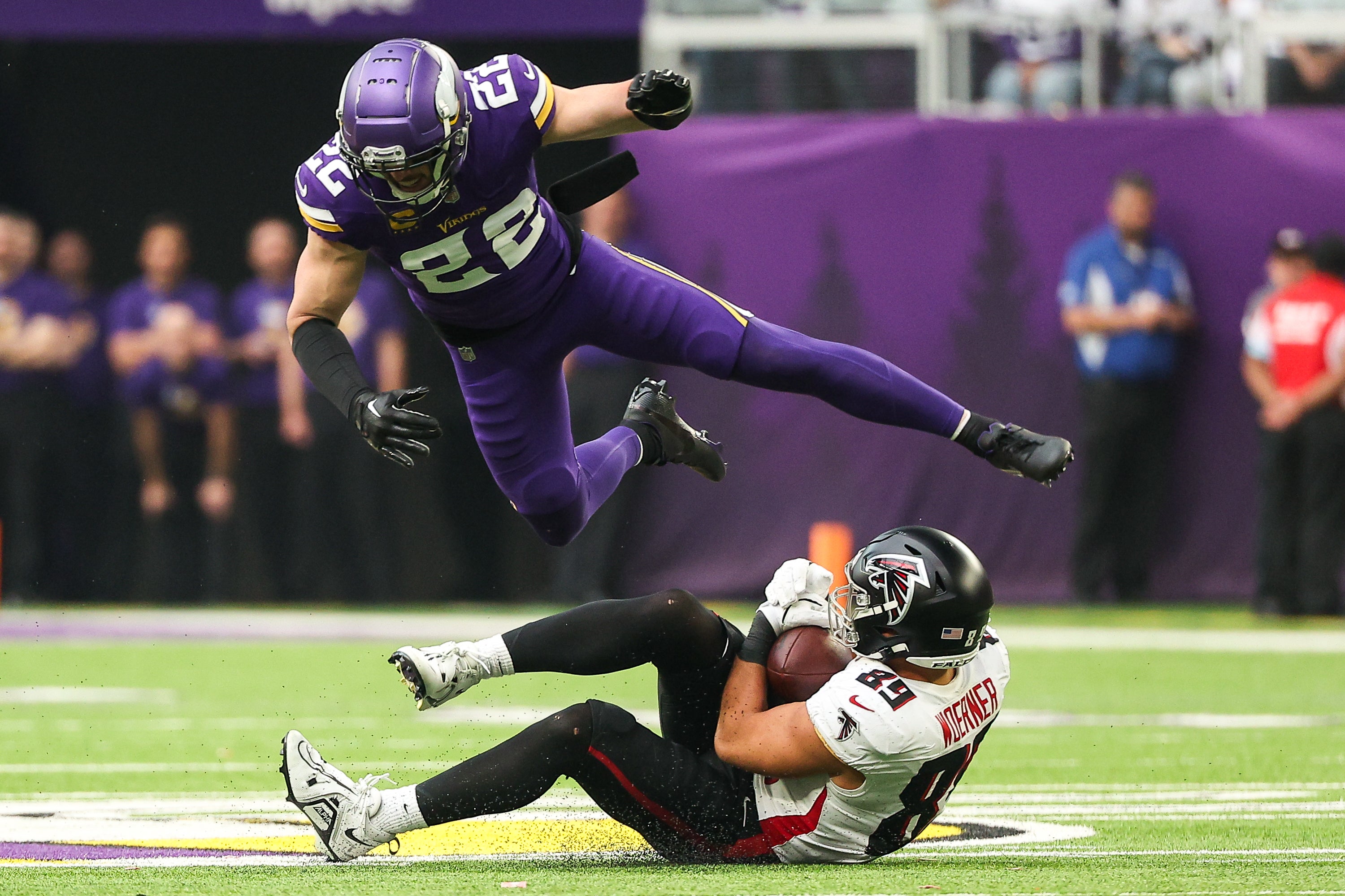 Dec 8, 2024; Minneapolis, Minnesota, USA; Atlanta Falcons tight end Charlie Woerner (89) catches a pass as Minnesota Vikings safety Harrison Smith (22) defends during the second quarter at U.S. Bank Stadium.