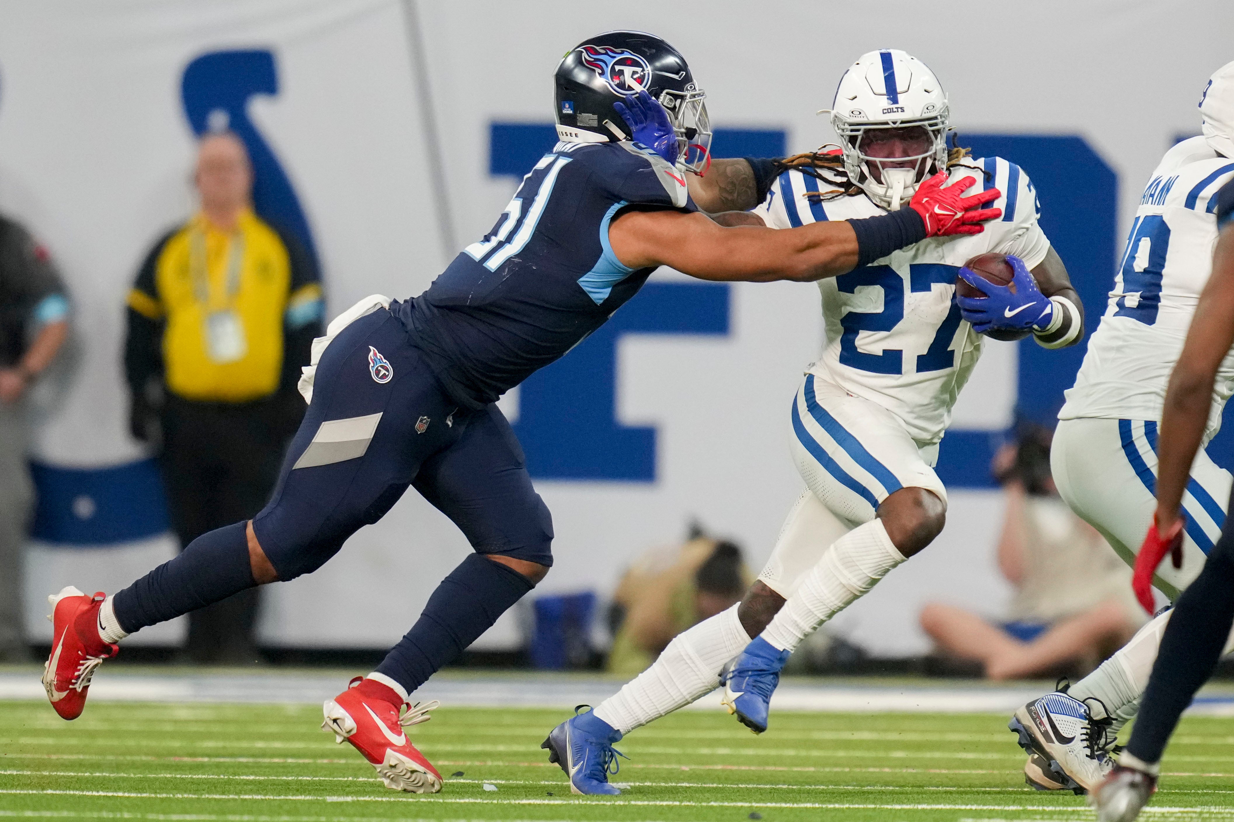 Tennessee Titans linebacker Cedric Gray (51) reaches for Indianapolis Colts running back Trey Sermon (27) during a game against the Tennessee Titans at Lucas Oil Stadium. Christine Tannous-USA Today Network via Imagn Images