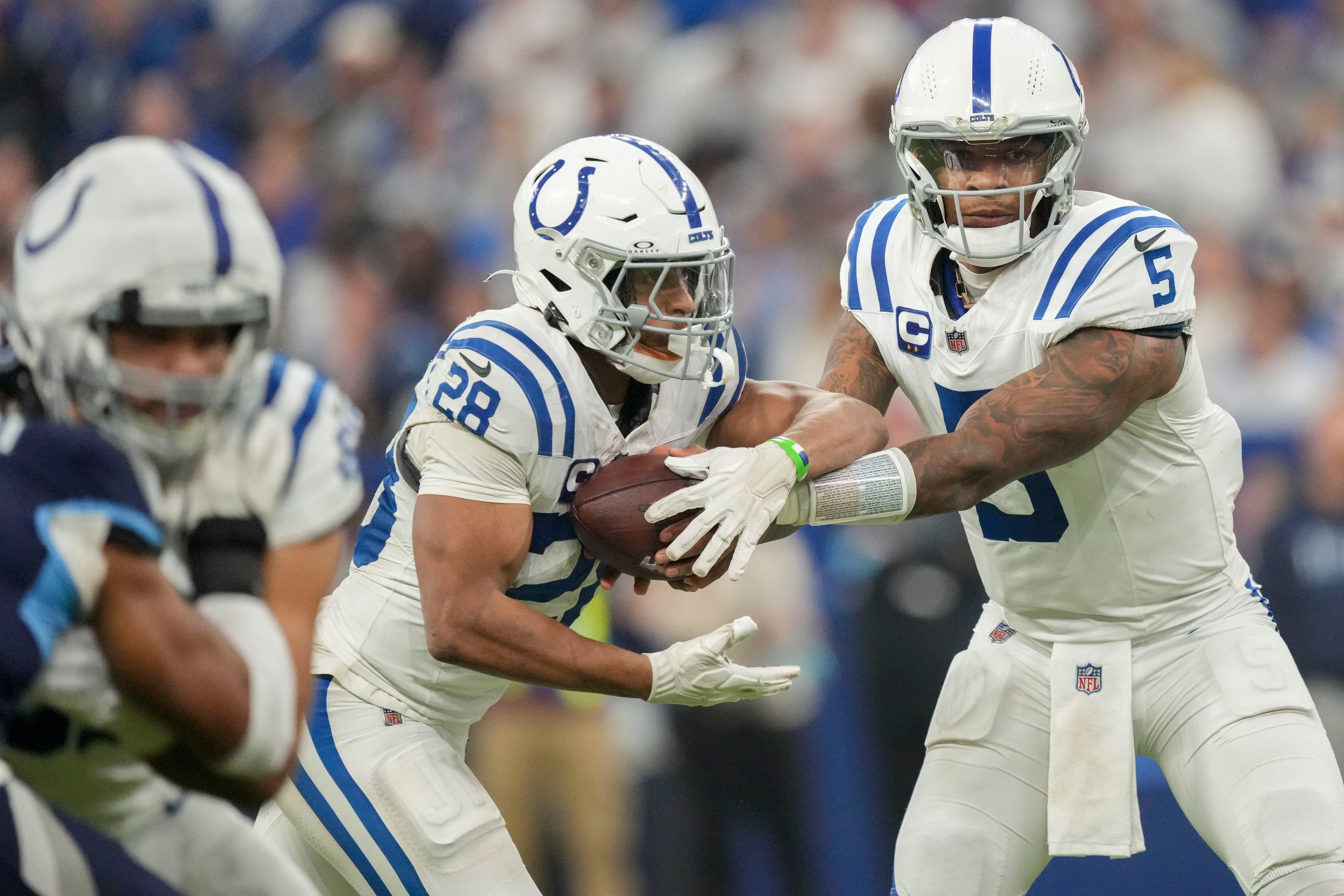 Indianapolis Colts quarterback Anthony Richardson (5) hands the ball off to Indianapolis Colts running back Jonathan Taylor (28) on Sunday, Dec. 22, 2024, during a game against the Tennessee Titans at Lucas Oil Stadium in Indianapolis.
