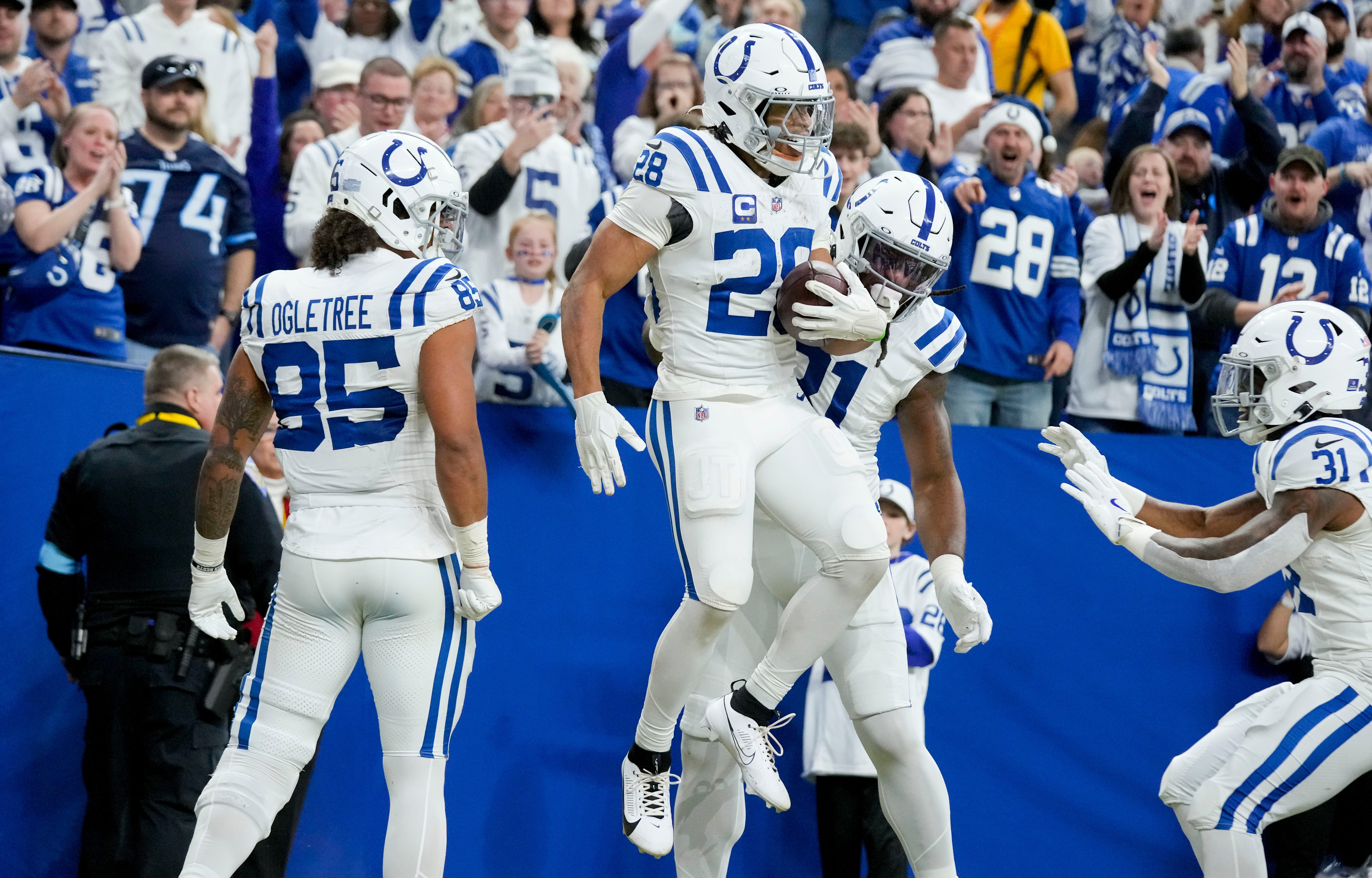 Indianapolis Colts running back Jonathan Taylor (28) celebrates with his teammates after rushing for a touchdown Sunday, Dec. 22, 2024, during a game against the Tennessee Titans at Lucas Oil Stadium in Indianapolis.