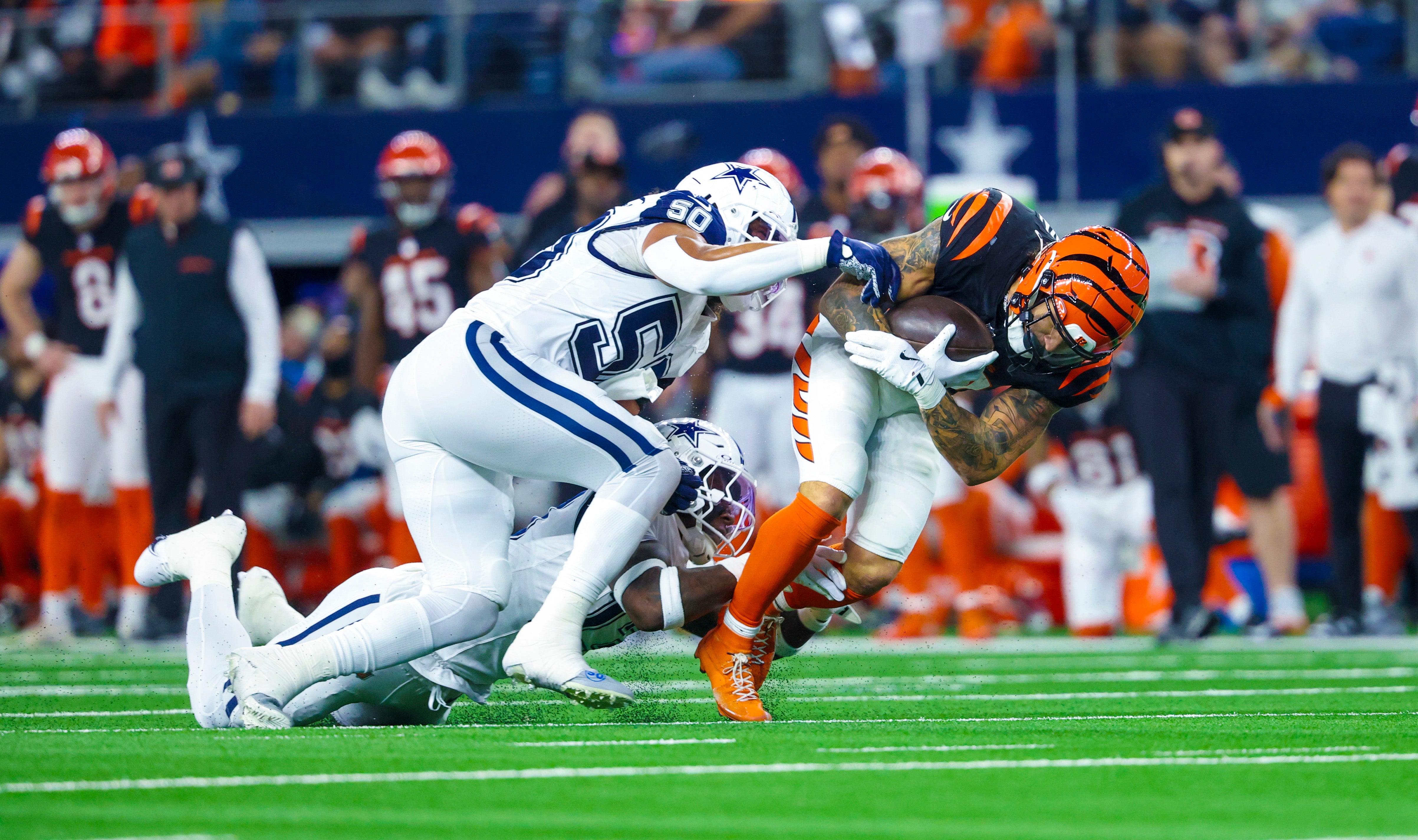 Cincinnati Bengals running back Chase Brown (30) runs with the ball as Dallas Cowboys linebacker Eric Kendricks (50) defends during the first half at AT&T Stadium.