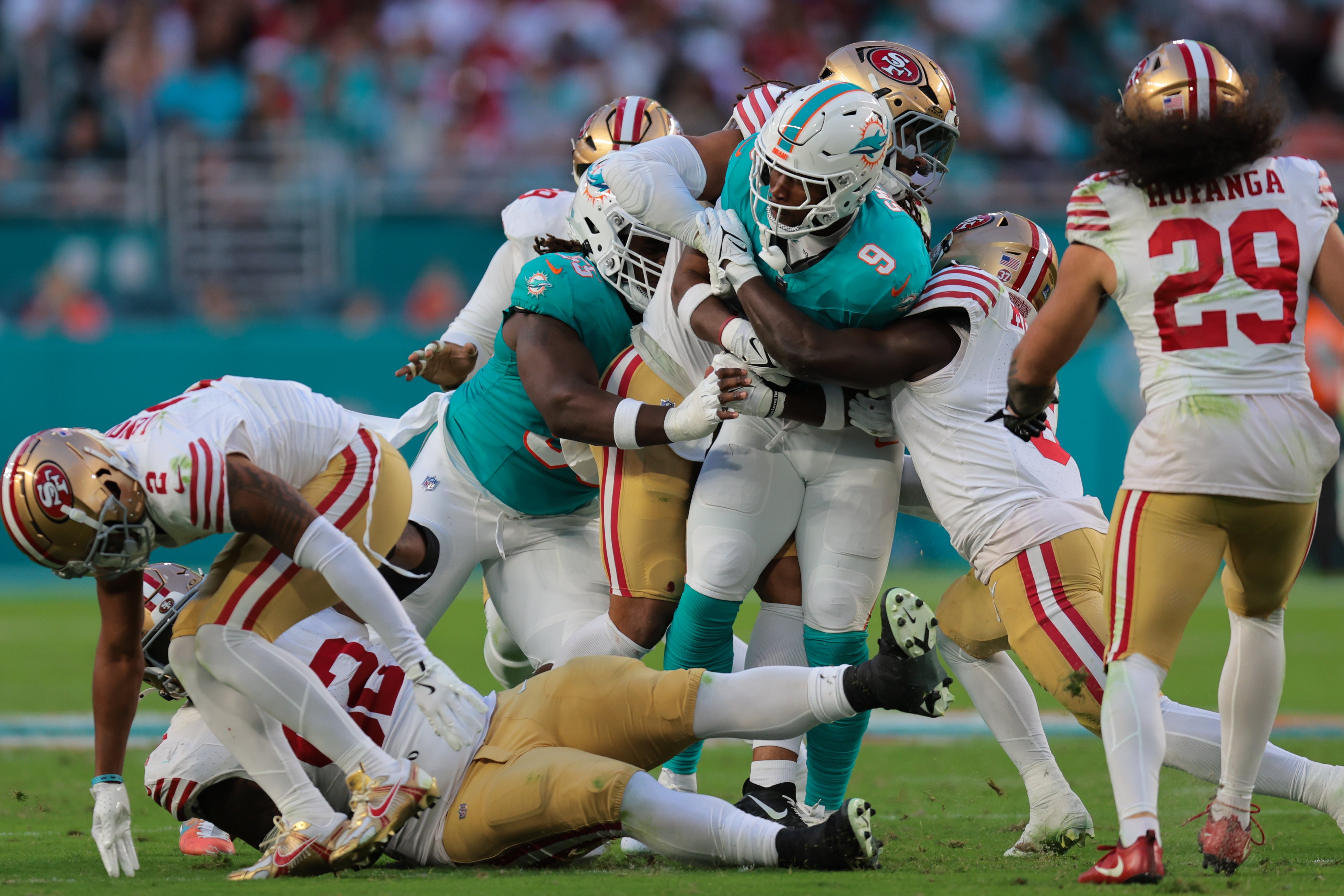 Dec 22, 2024; Miami Gardens, Florida, USA; Miami Dolphins tight end Jonnu Smith (9) runs with the football against San Francisco 49ers safety Malik Mustapha (6) during the second quarter at Hard Rock Stadium.