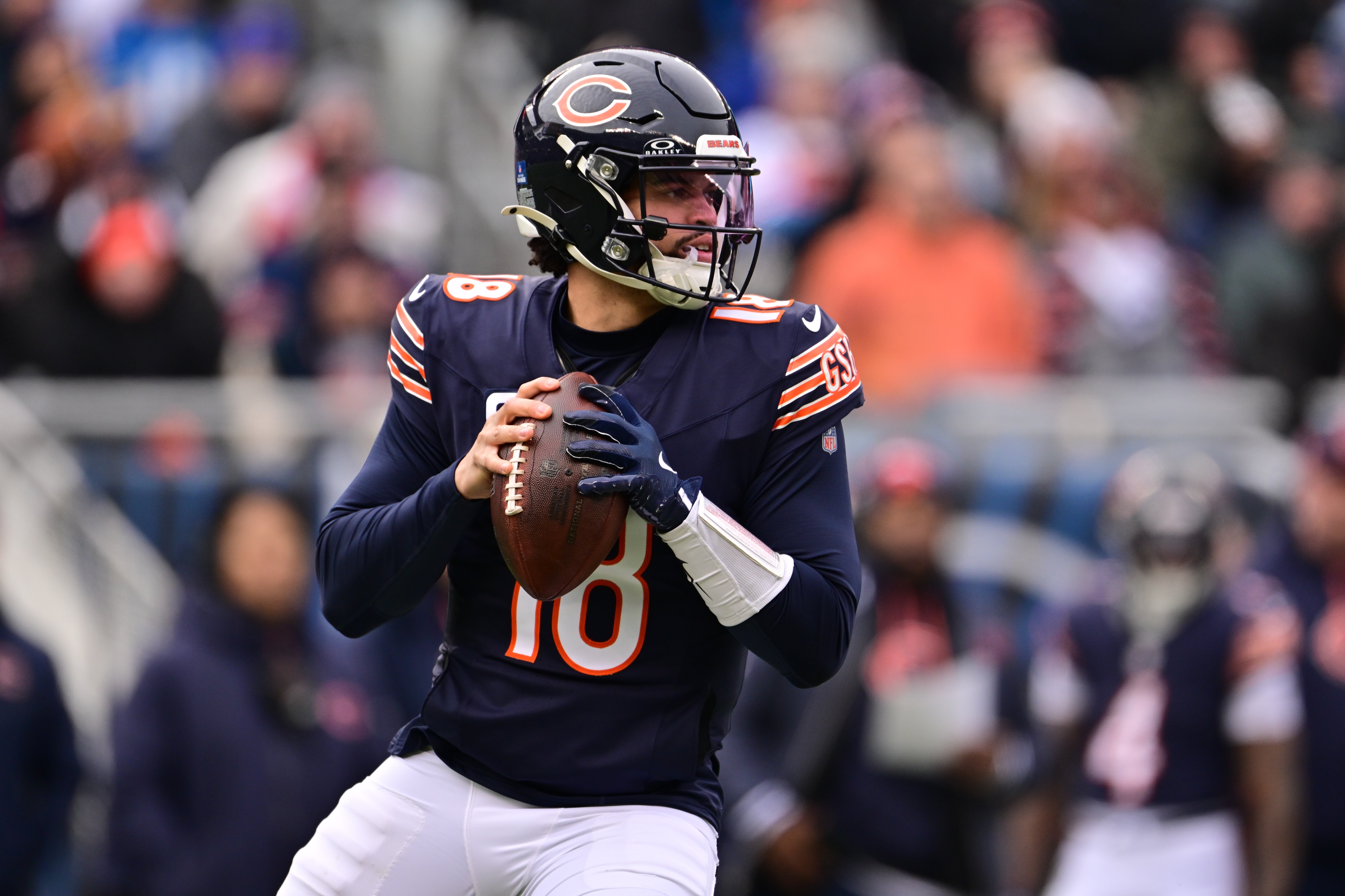 Dec 22, 2024; Chicago, Illinois, USA; Chicago Bears quarterback Caleb Williams (18) looks to pass against the Detroit Lions during the second quarter at Soldier Field.