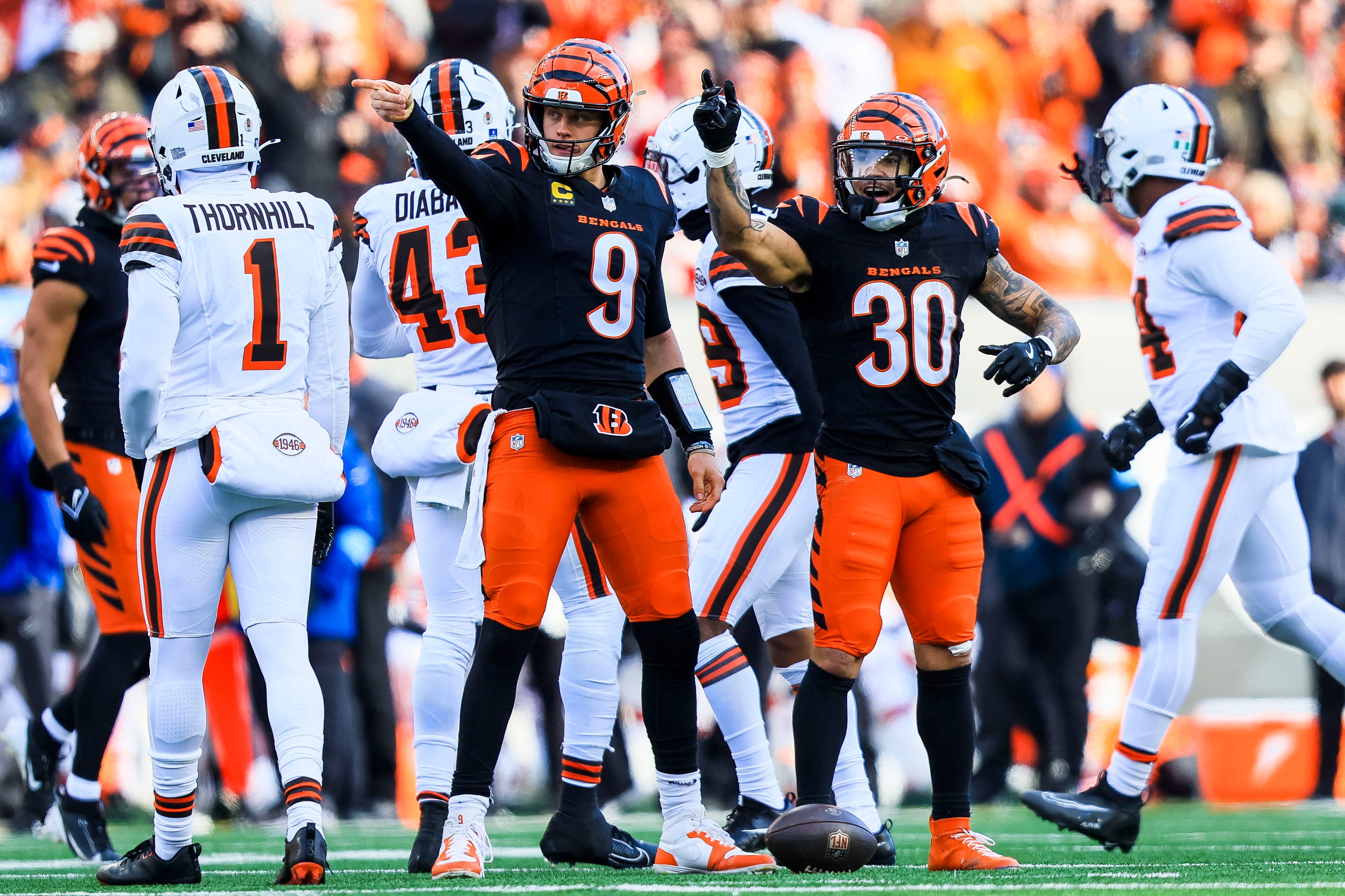 Dec 22, 2024; Cincinnati, Ohio, USA; Cincinnati Bengals quarterback Joe Burrow (9) reacts after advancing the ball with running back Chase Brown (30) in the first half against the Cleveland Browns at Paycor Stadium.