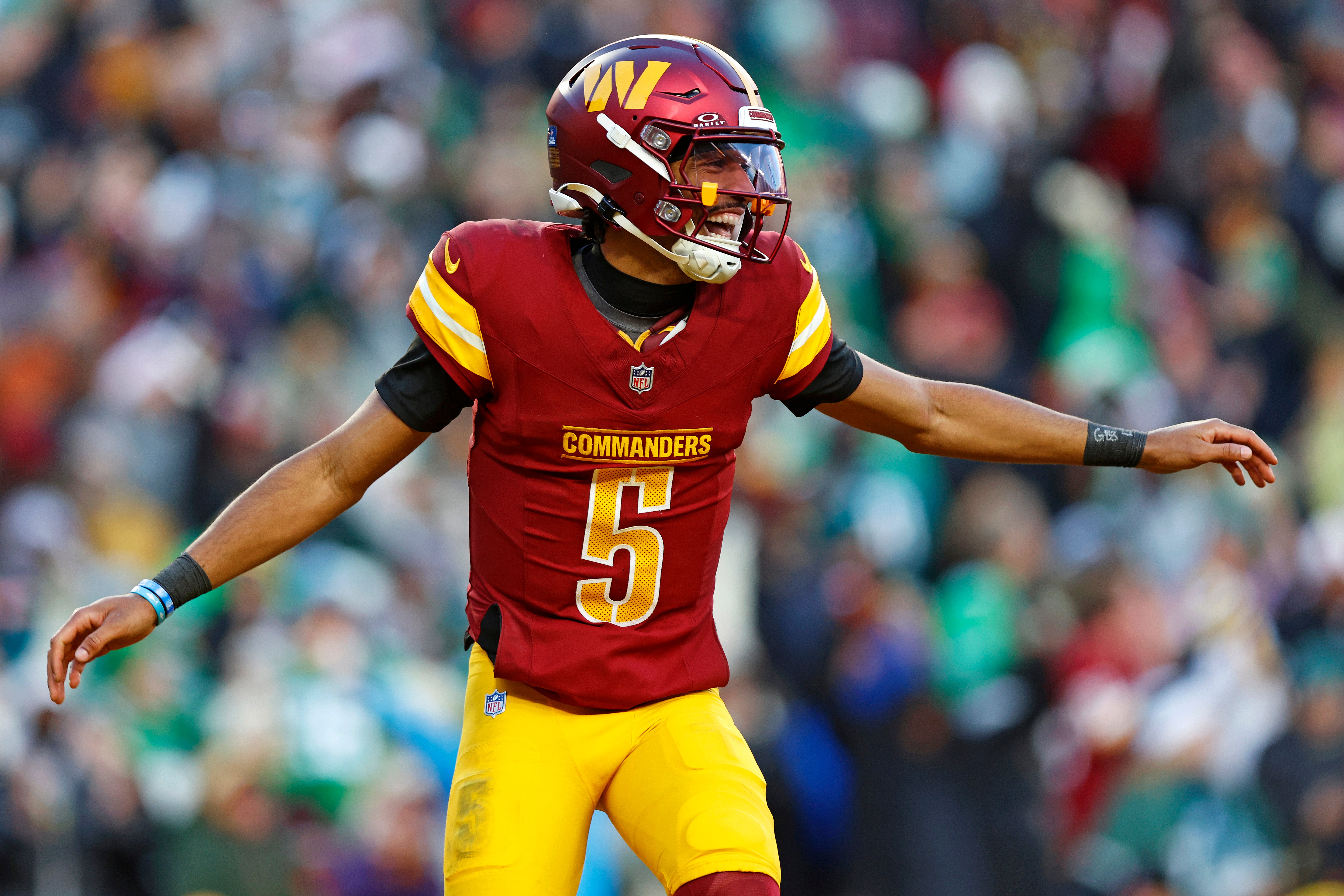 Washington Commanders quarterback Jayden Daniels (5) celebrates after throwing a touchdown during the fourth quarter against the Philadelphia Eagles at Northwest Stadium.