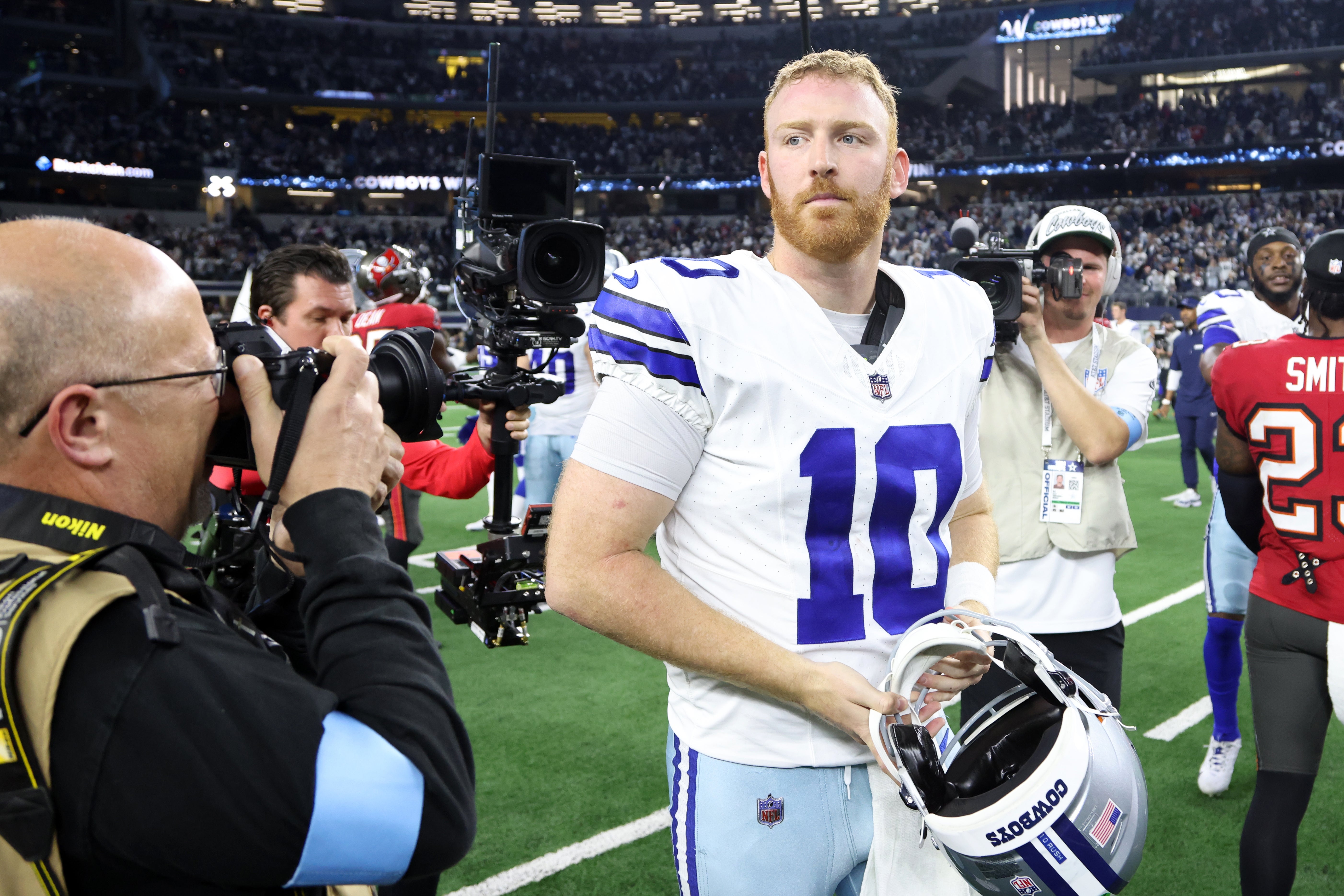 Dallas Cowboys quarterback Cooper Rush (10) walks off the field after the game against the Tampa Bay Buccaneers at AT&T Stadium.