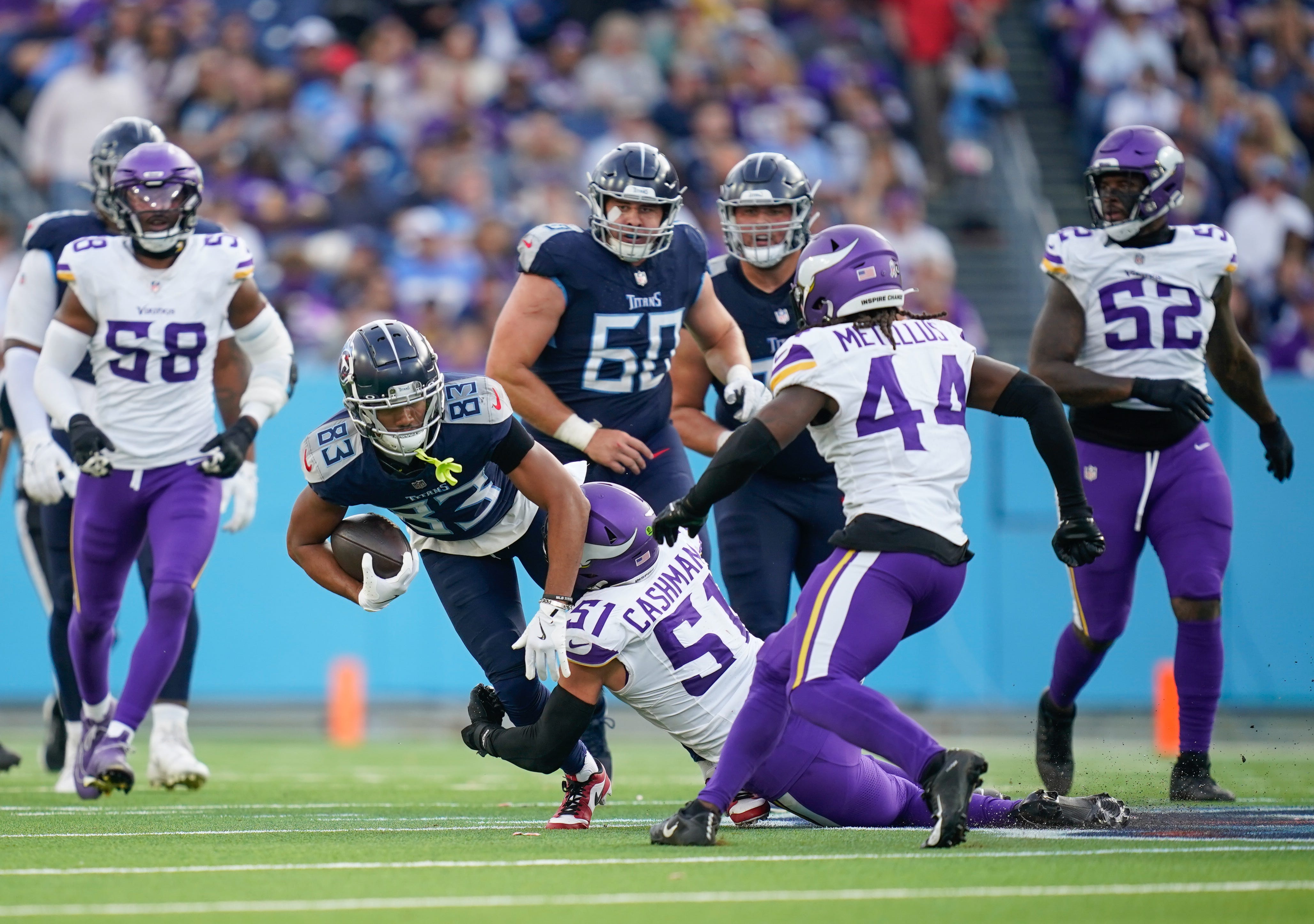 Tennessee Titans wide receiver Tyler Boyd (83) is brought down by Minnesota Vikings linebacker Blake Cashman (51) during the fourth quarter at Nissan Stadium in Nashville, Tenn., Sunday, Nov. 17, 2024.