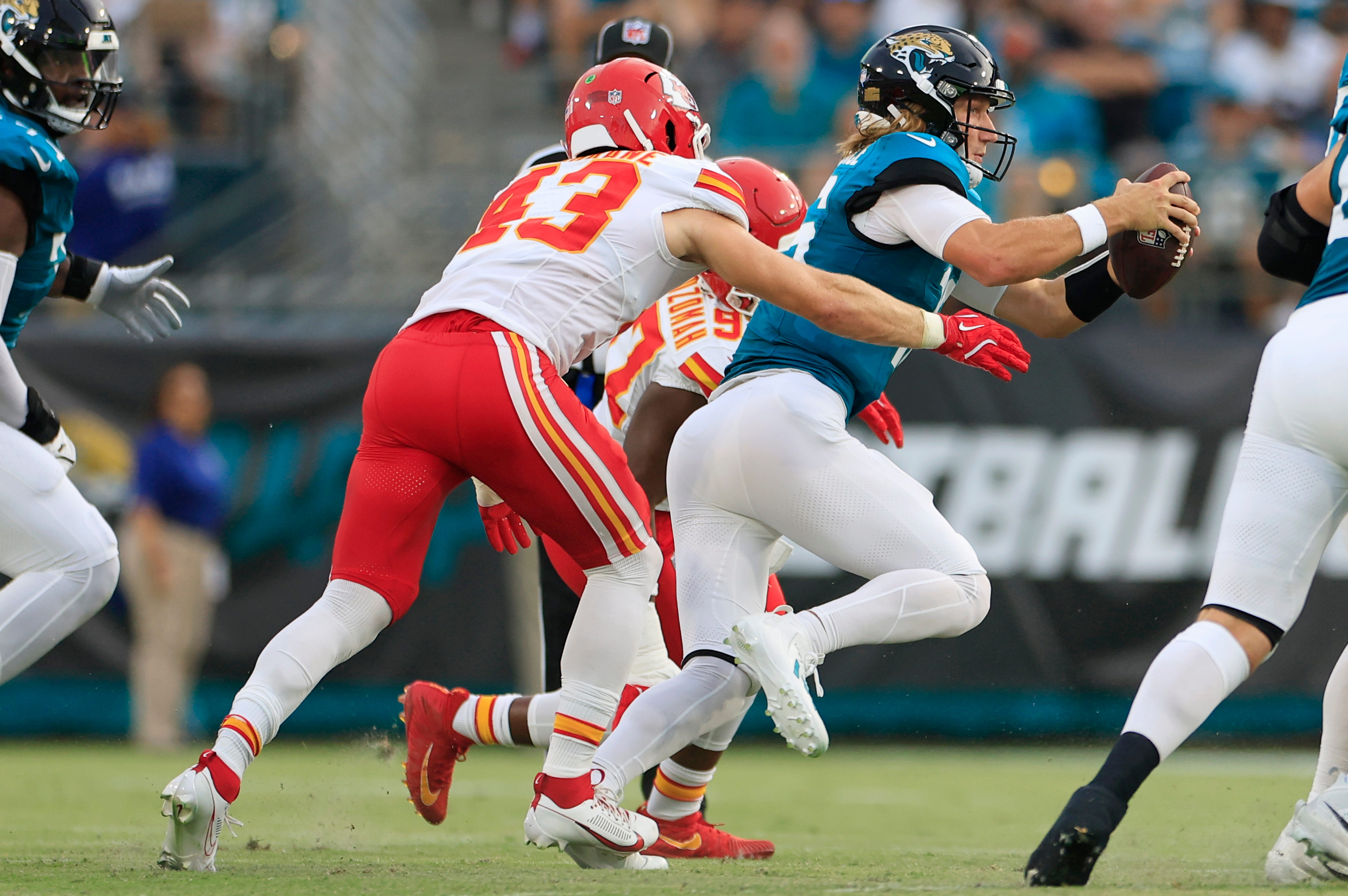 Jaguars quarterback Trevor Lawrence (16) is sacked by Kansas City Chiefs linebacker Jack Cochrane (43)
