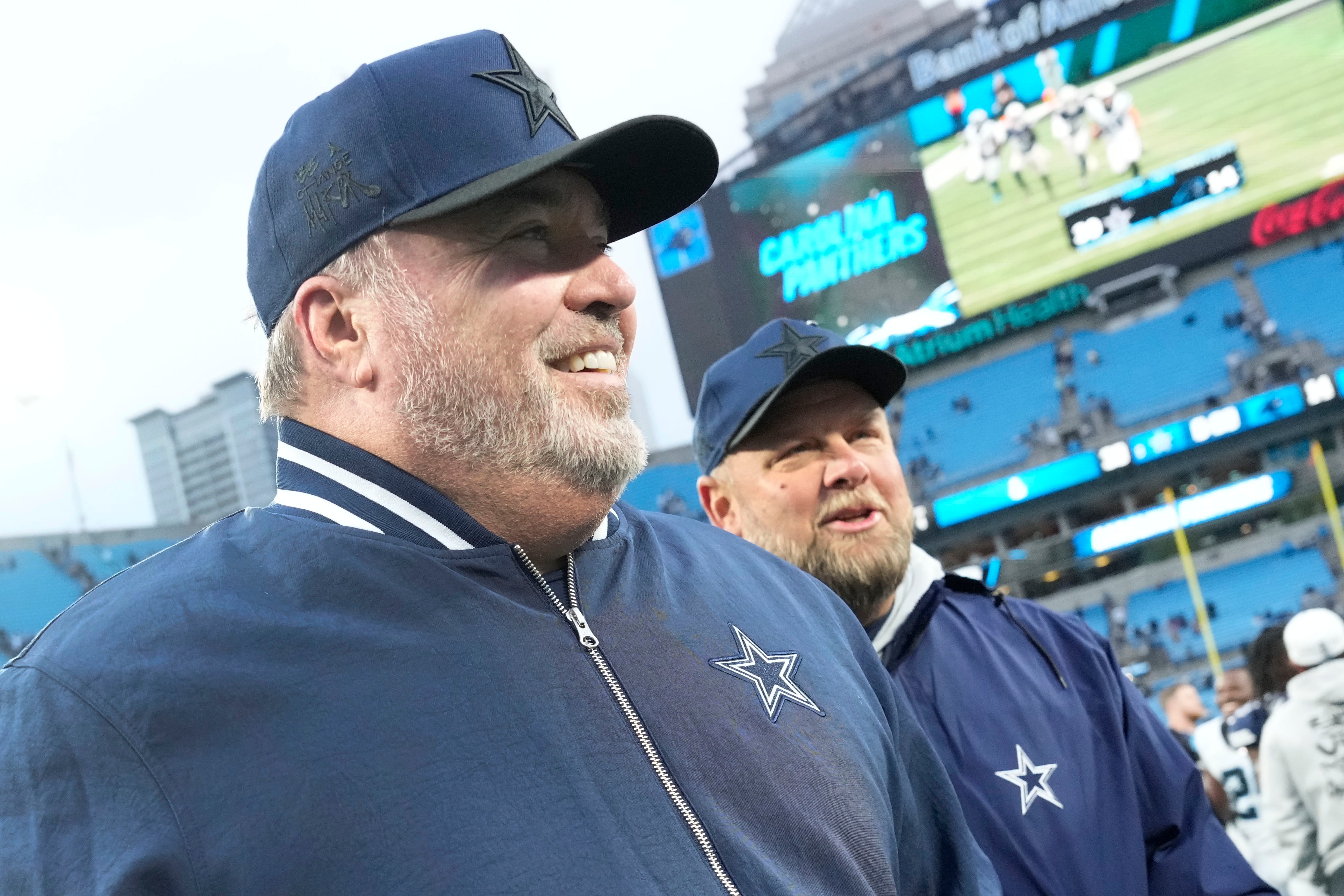 Dallas Cowboys head coach Mike McCarthy walks off the field after the game at Bank of America Stadium.