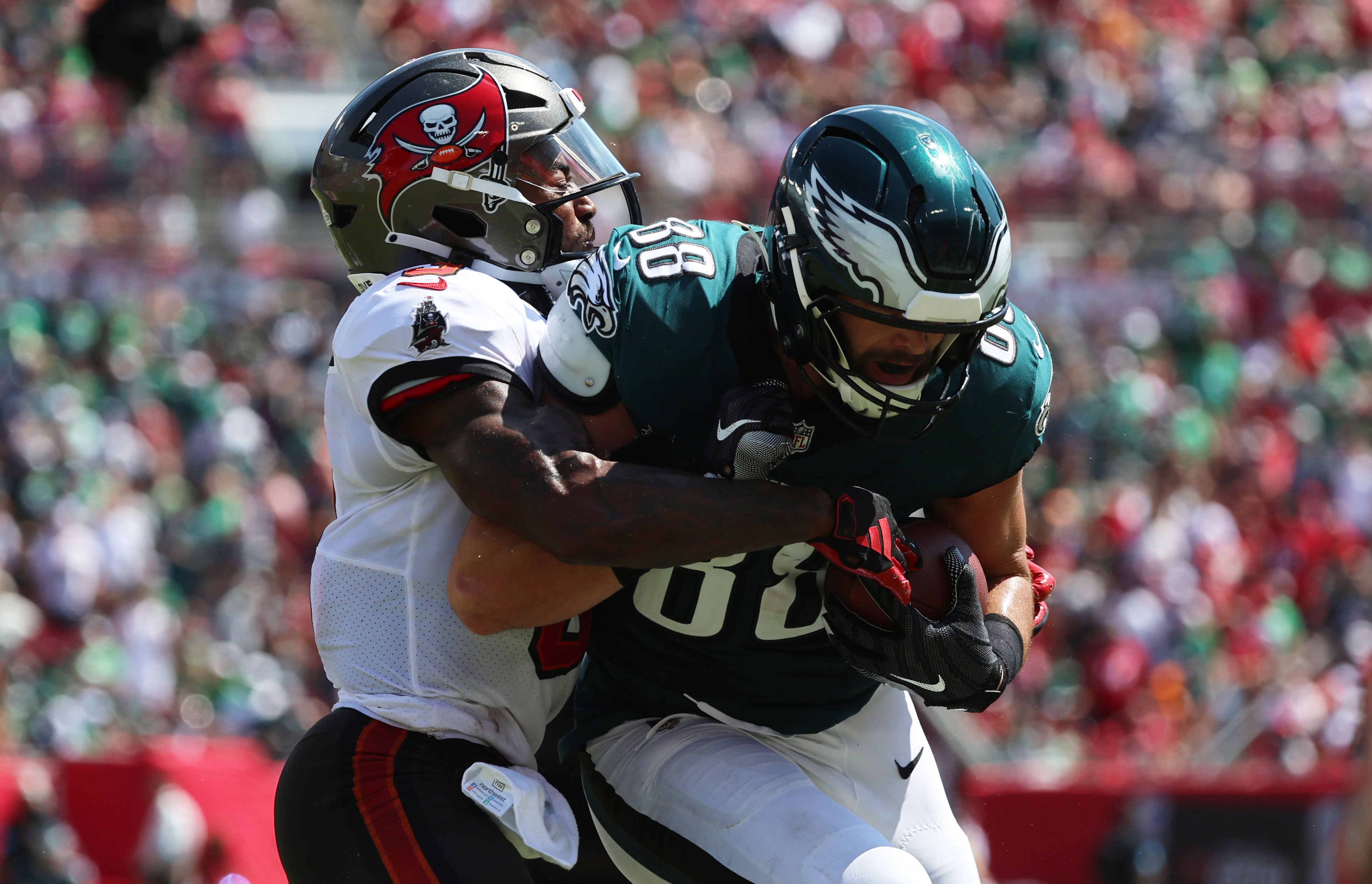 Sep 29, 2024; Tampa, Florida, USA; Philadelphia Eagles tight end Dallas Goedert (88) runs with the ball as Tampa Bay Buccaneers safety Jordan Whitehead (3) tackles during the first half at Raymond James Stadium.