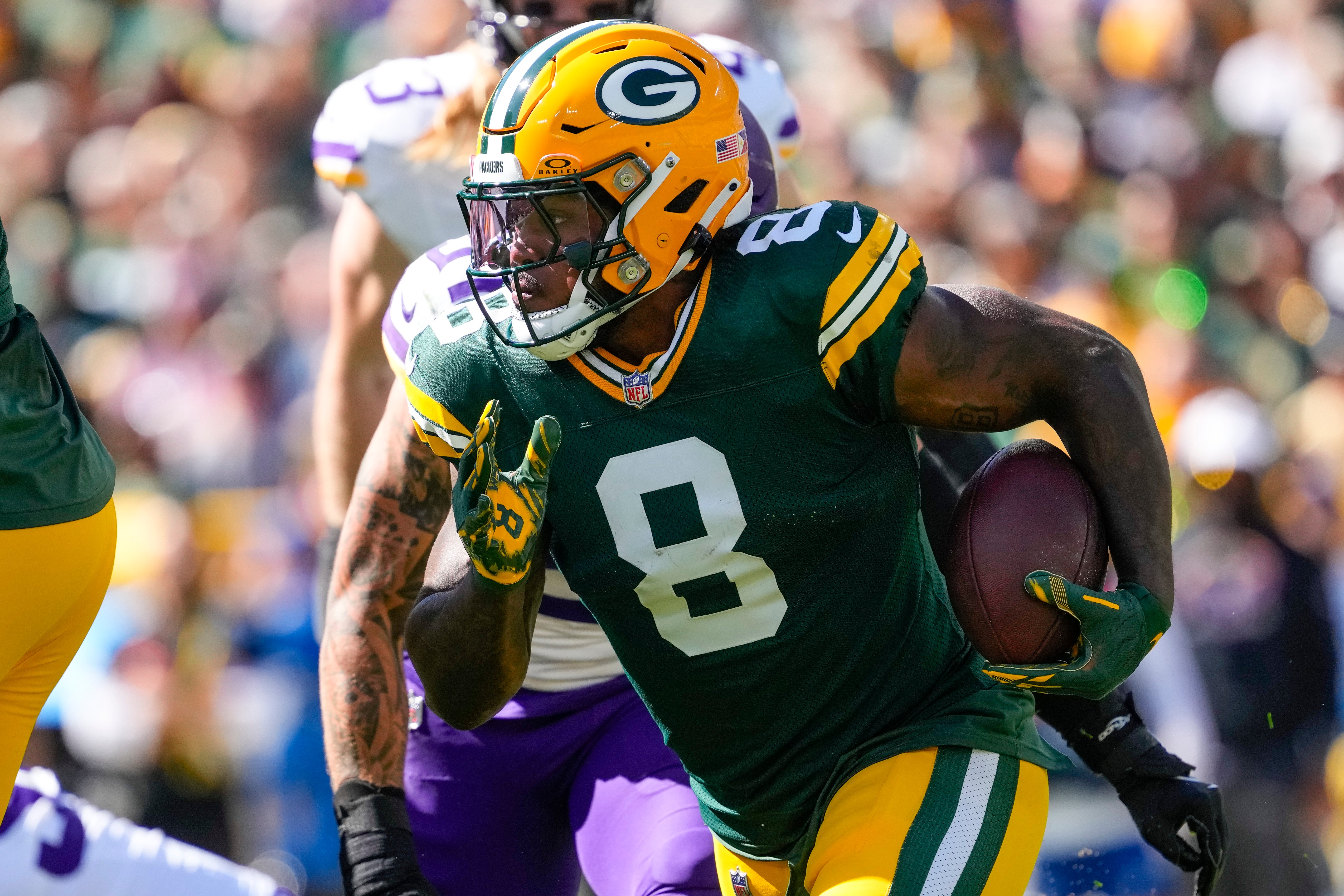 Green Bay Packers running back Josh Jacobs (8) rushes with the football during the first quarter against the Minnesota Vikings at Lambeau Field.