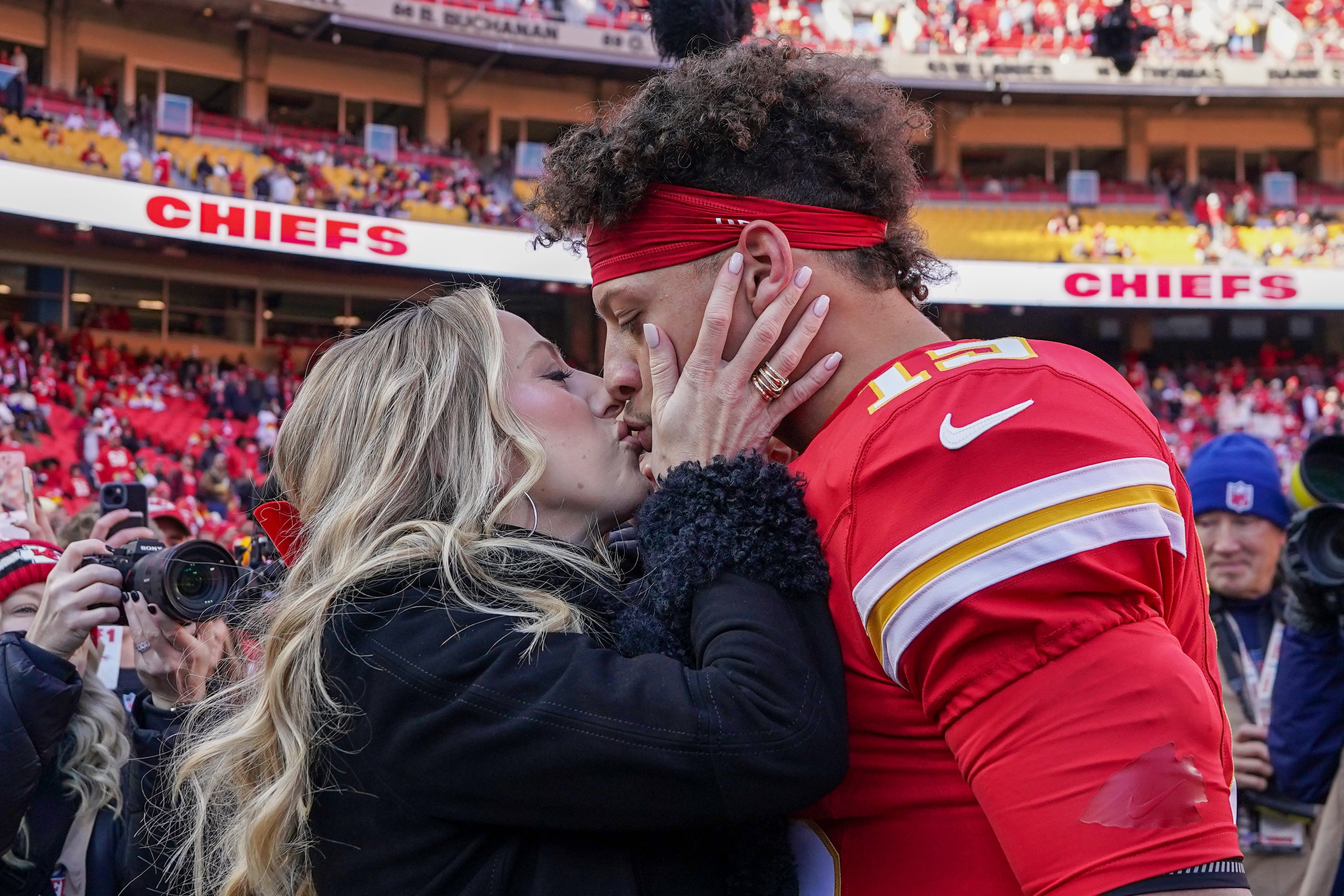 Nov 29, 2024; Kansas City, Missouri, USA; Kansas City Chiefs quarterback Patrick Mahomes (15) kisses his wife Brittany prior to a game against the Las Vegas Raiders at GEHA Field at Arrowhead Stadium