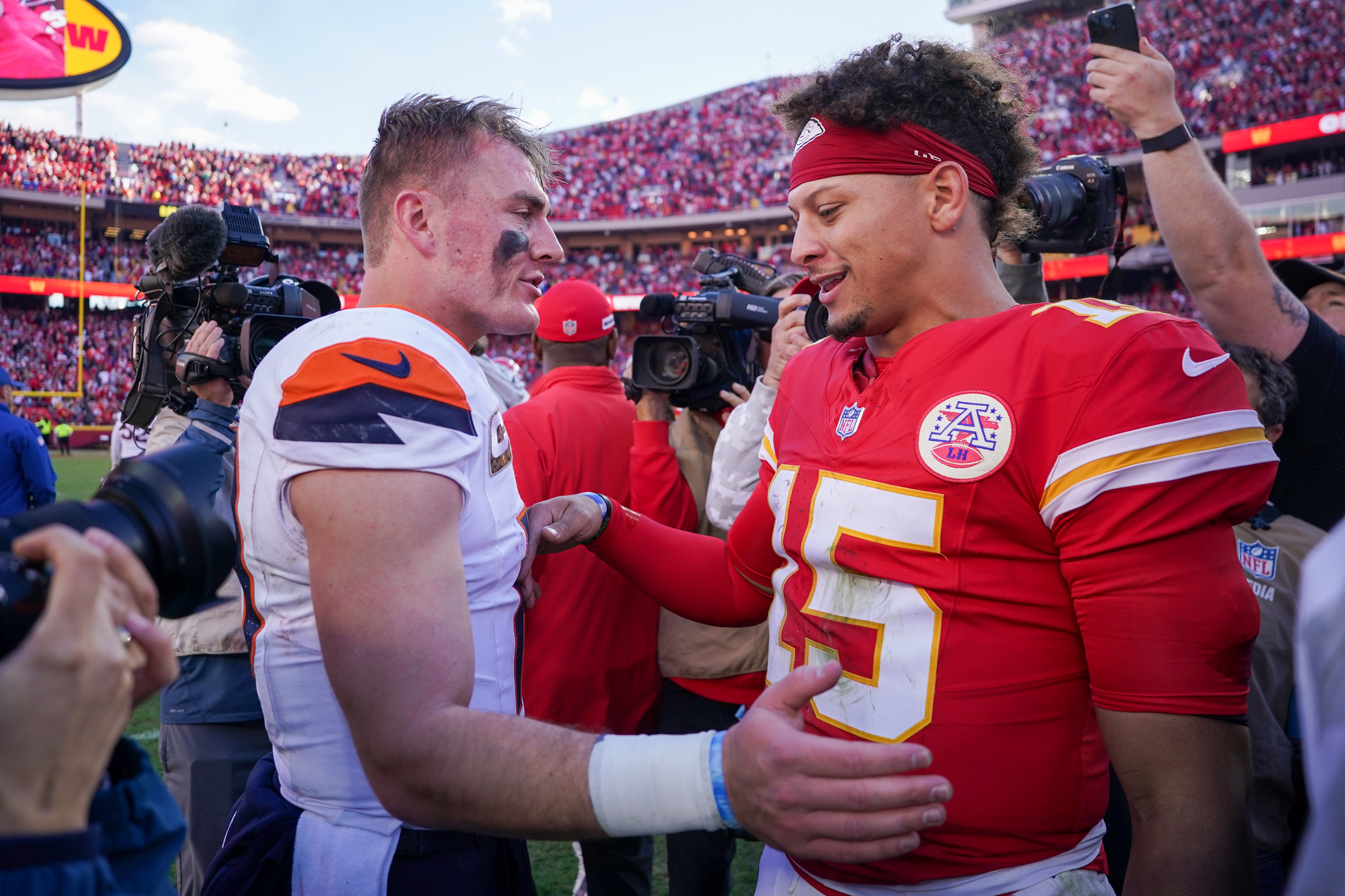 Broncos quarterback Bo Nix (10) talks with Chiefs quarterback Patrick Mahomes (15) after the game in Week 10.