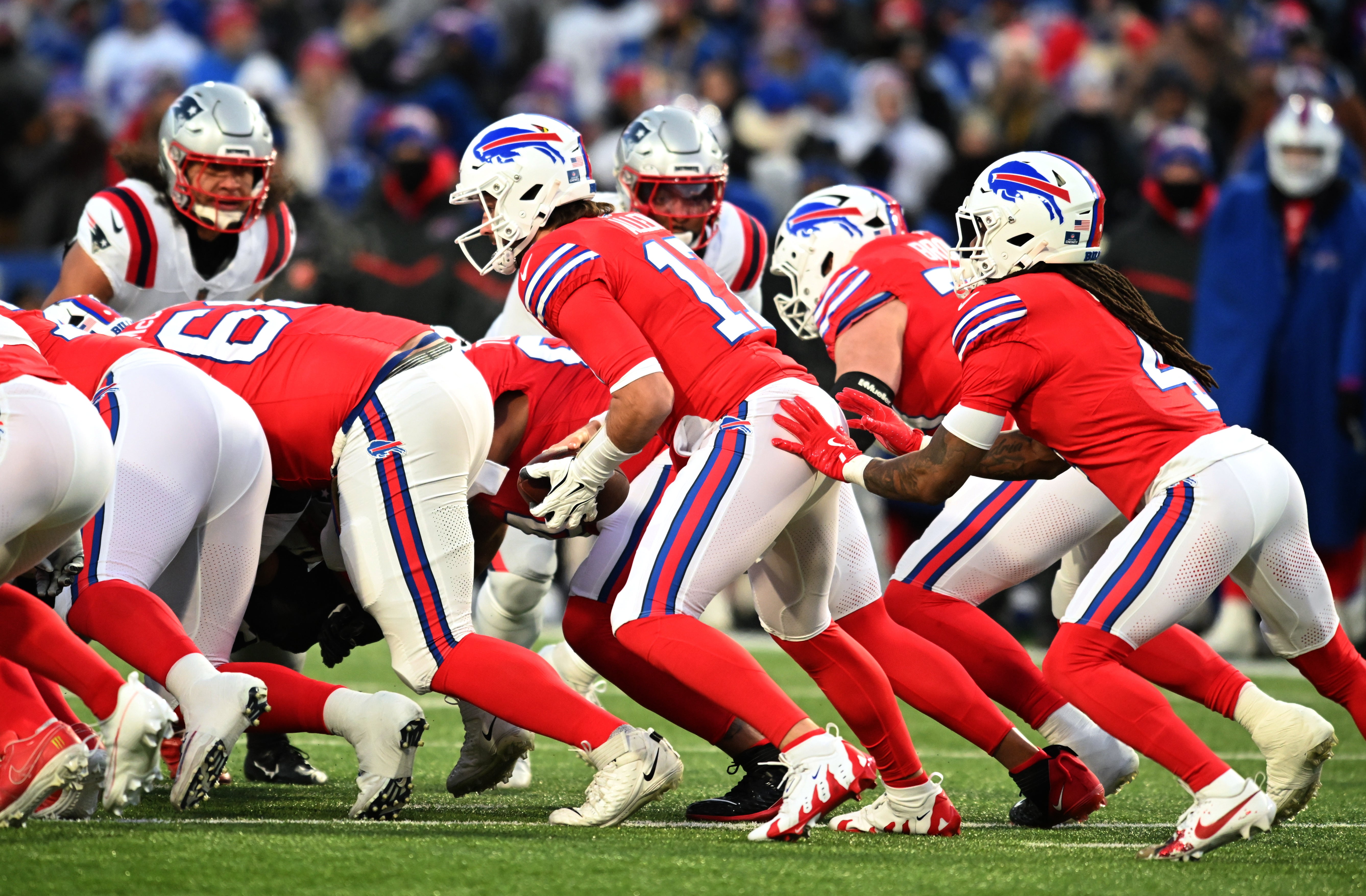 Dec 22, 2024; Orchard Park, New York, USA; Buffalo Bills quarterback Josh Allen (17) is pushed by running back James Cook (4) to gain a first down against the New England Patriots in the first quarter at Highmark Stadium.