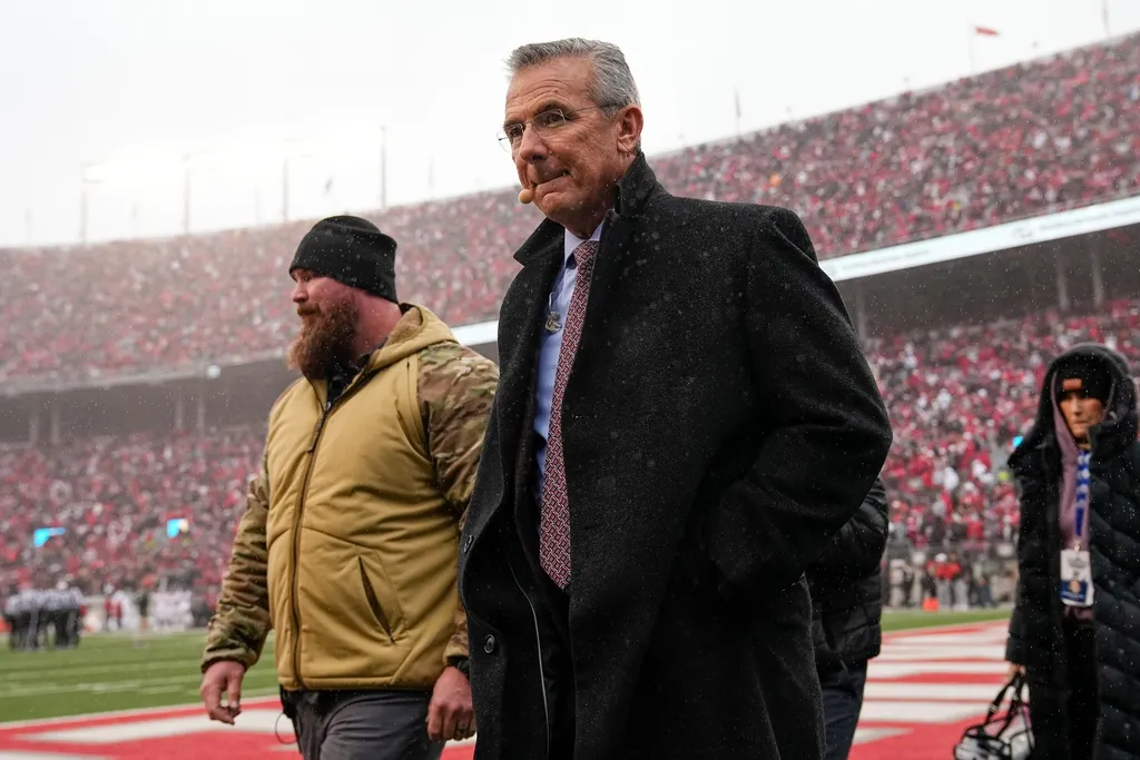 Former Ohio State Buckeyes coach Urban Meyer walks across the field during the NCAA football game against the Indiana Hoosiers at Ohio Stadium in Columbus on Monday, Nov. 25, 2024. 