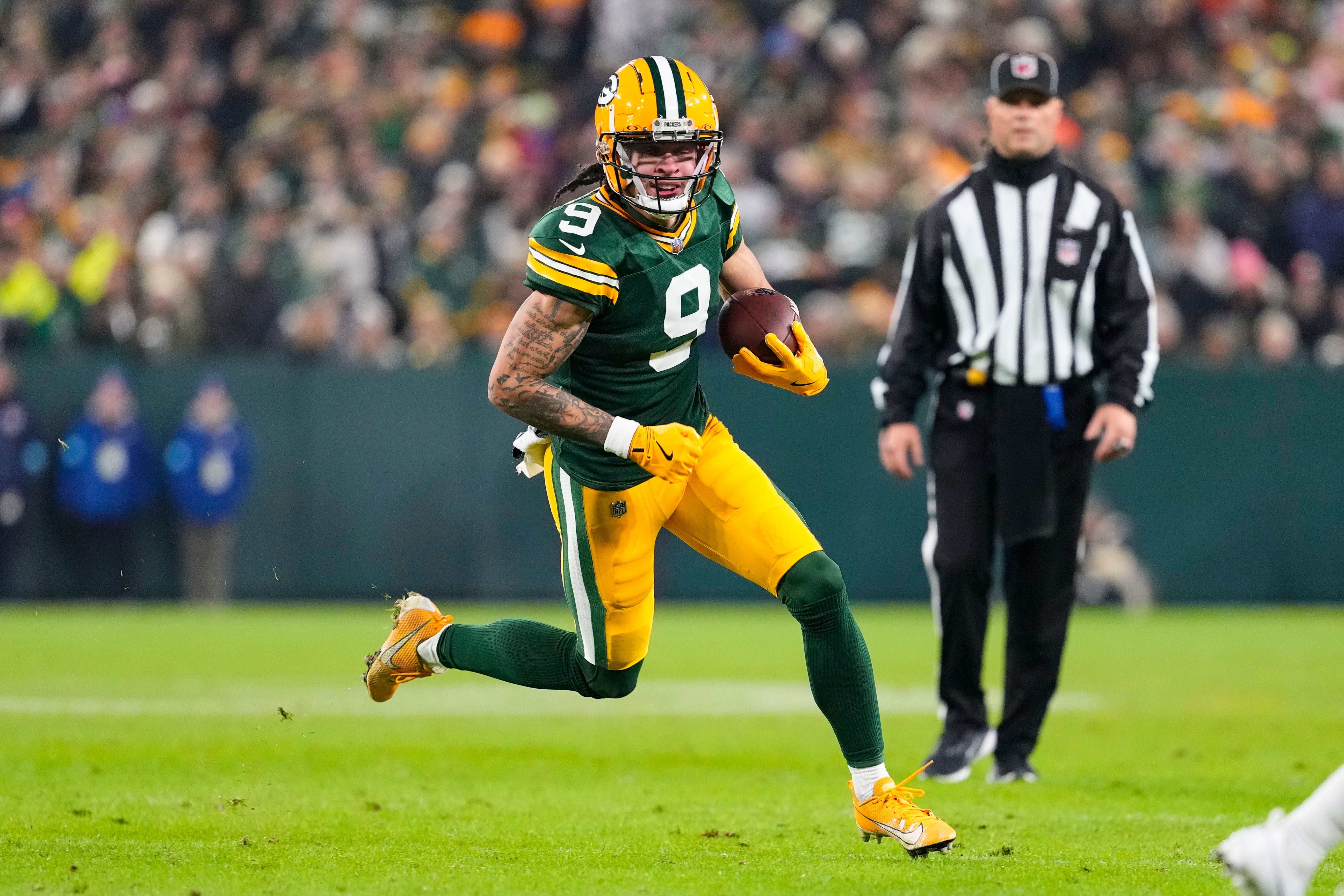 Green Bay Packers wide receiver Christian Watson (9) rushes with the football during the second quarter against the New Orleans Saints at Lambeau Field.