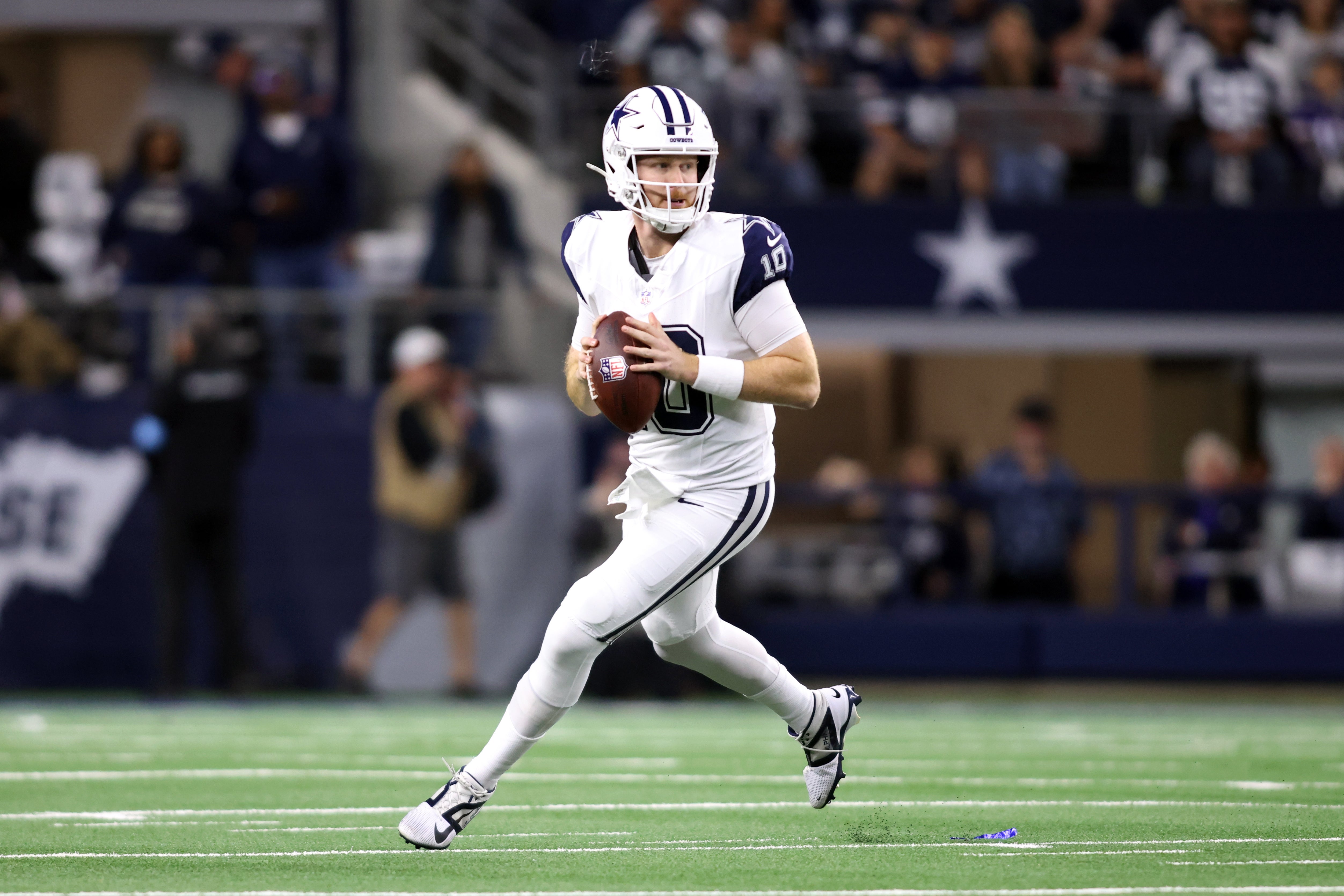 Dallas Cowboys quarterback Cooper Rush (10) rolls out to pass against the Cincinnati Bengals in the first quarter at AT&T Stadium.