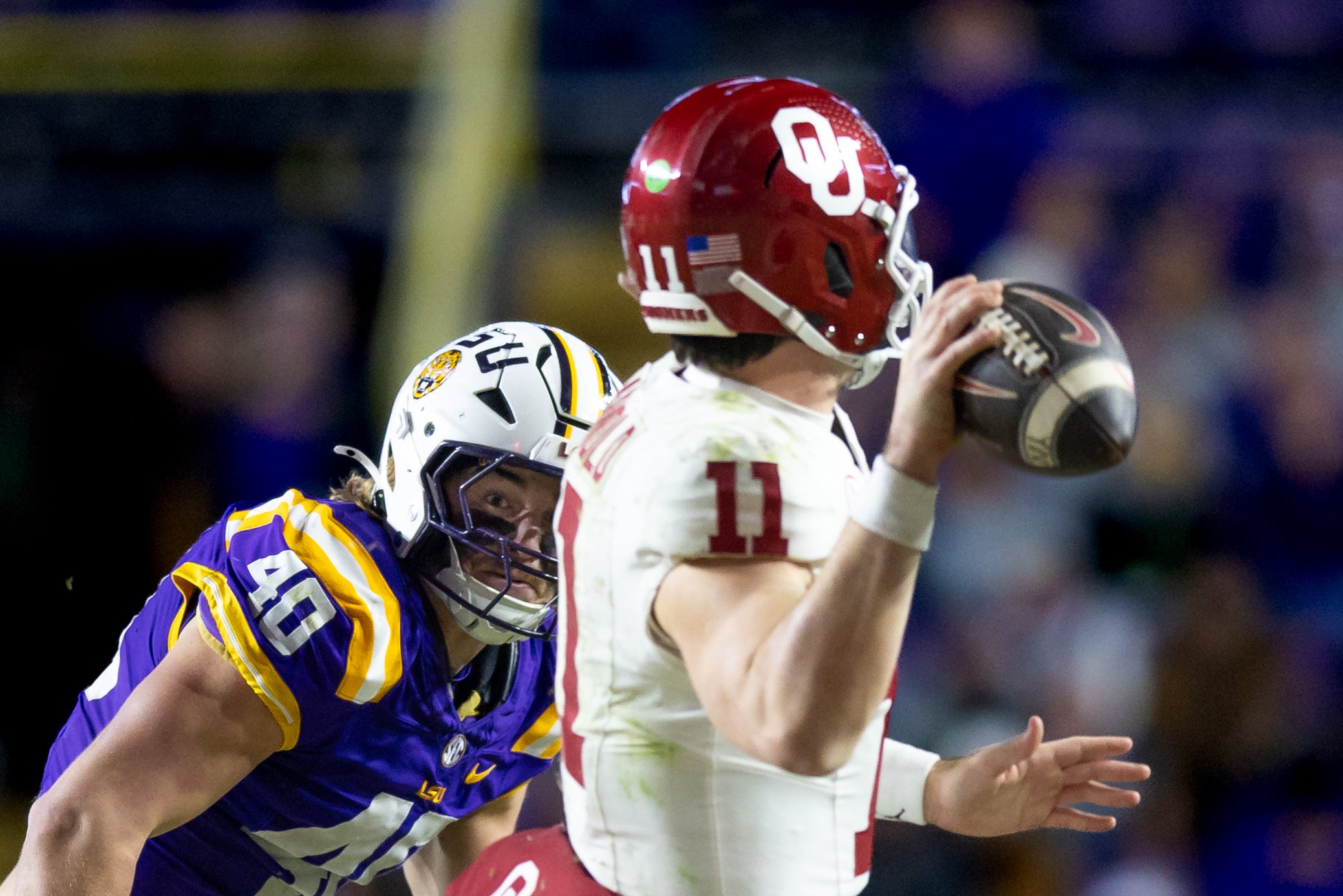 LSU Tigers linebacker Whit Weeks (40) chases Oklahoma Sooners quarterback Jackson Arnold (11) and forces an incomplete pass during the fourth quarter at Tiger Stadium.