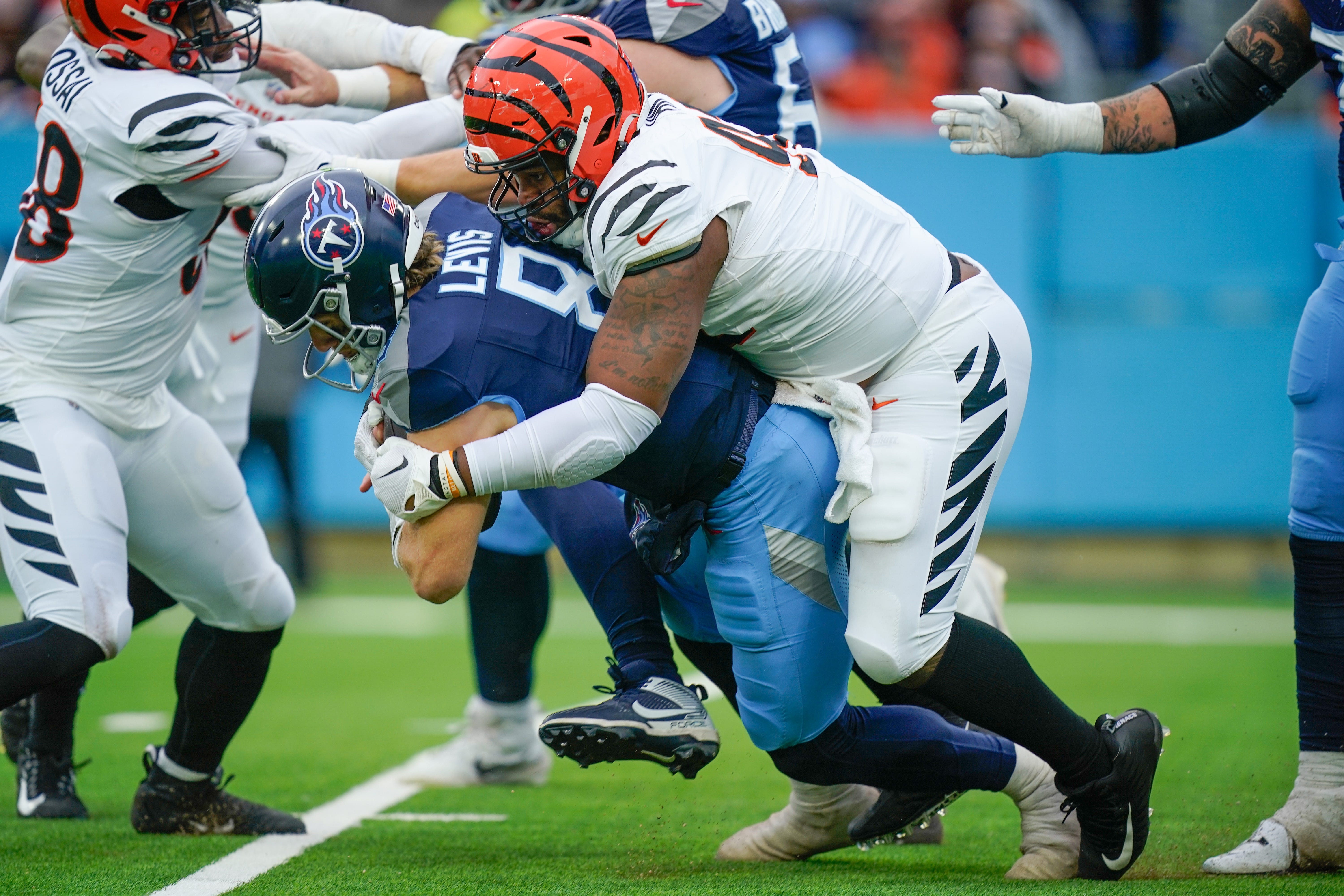Cincinnati Bengals defensive tackle B.J. Hill (92) sacks Tennessee Titans quarterback Will Levis (8) during the third quarter at Nissan Stadium in Nashville, Tenn., Sunday, Dec. 15, 2024.
