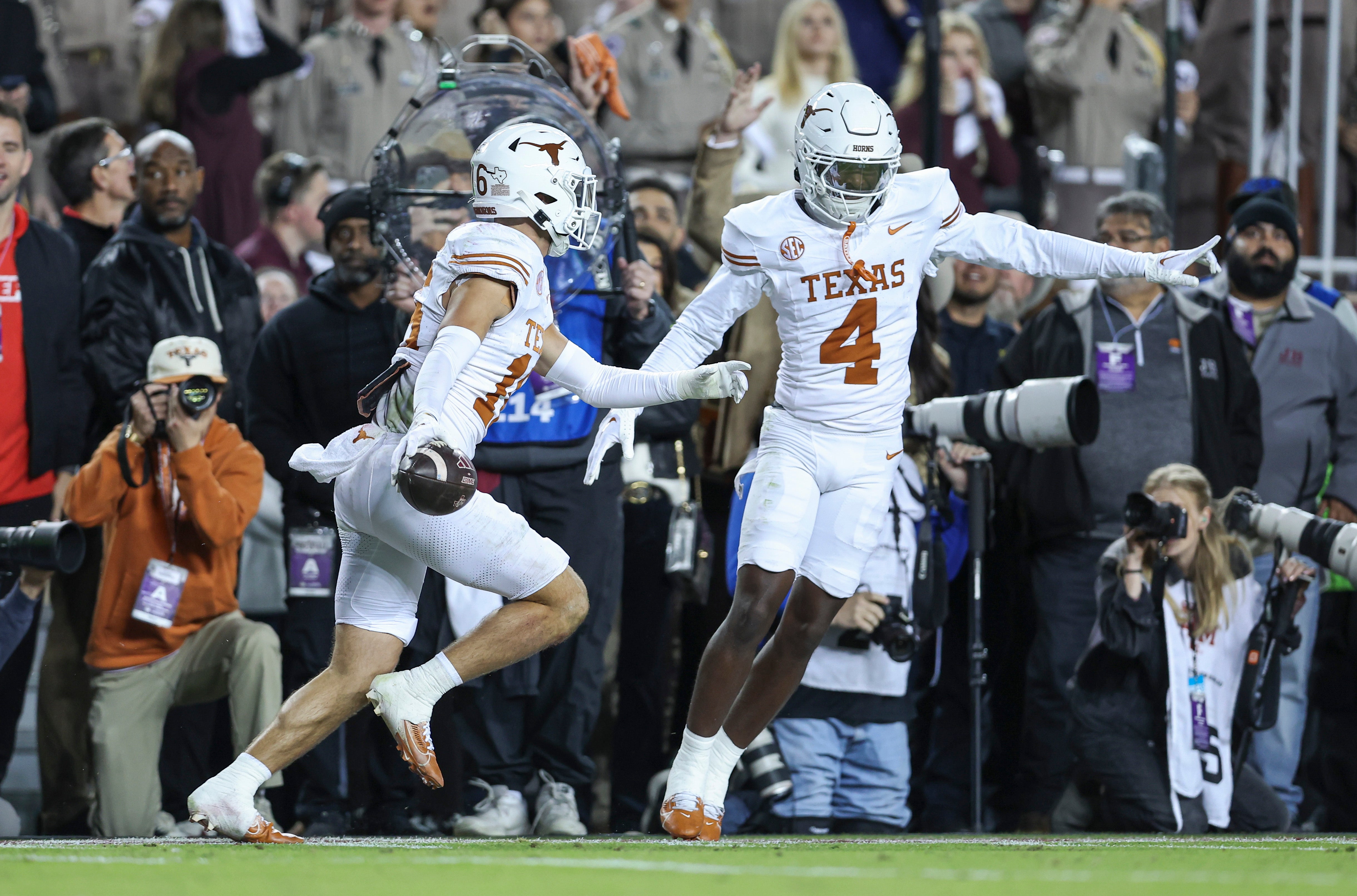 Texas Longhorns defensive back Michael Taaffe (16) celebrates with defensive back Andrew Mukuba (4) after an interception during the first quarter against the Texas A&M Aggies at Kyle Field.