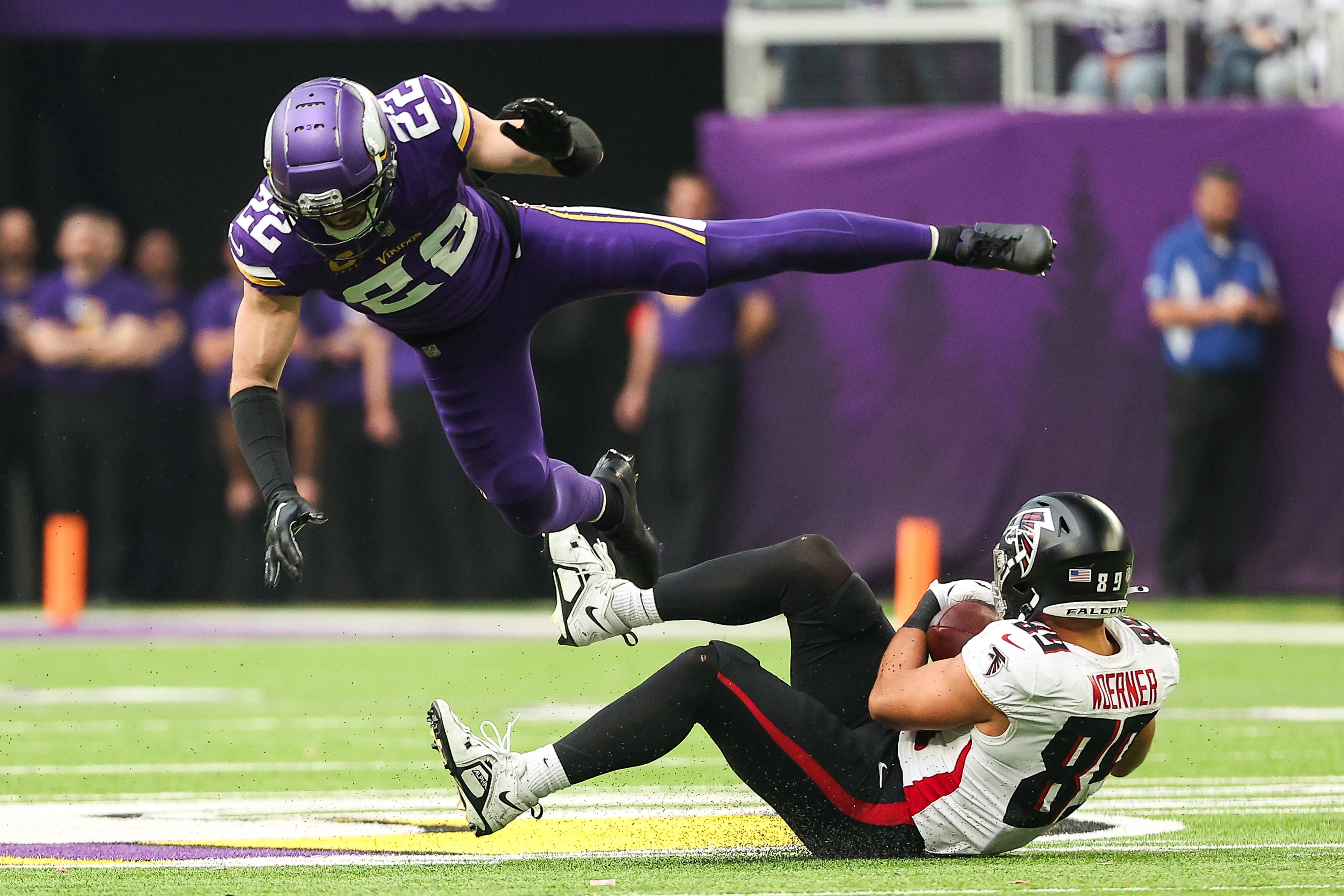 Dec 8, 2024; Minneapolis, Minnesota, USA; Atlanta Falcons tight end Charlie Woerner (89) catches a pass as Minnesota Vikings safety Harrison Smith (22) defends during the second quarter at U.S. Bank Stadium.