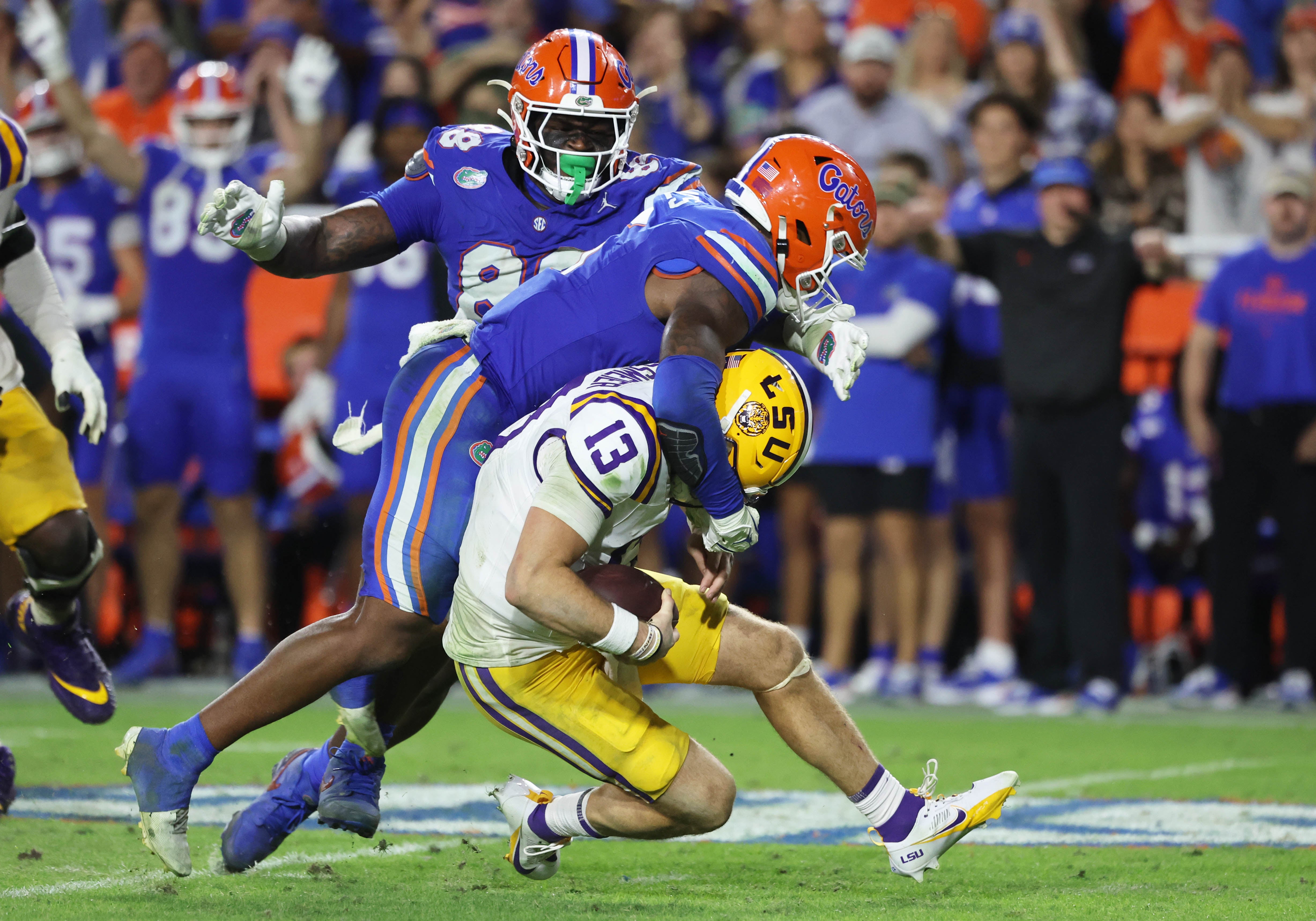 Nov 16, 2024; Gainesville, Florida, USA; Florida Gators linebacker Shemar James (6) and defensive lineman Caleb Banks (88) sack LSU Tigers quarterback Garrett Nussmeier (13) during the second half at Ben Hill Griffin Stadium.