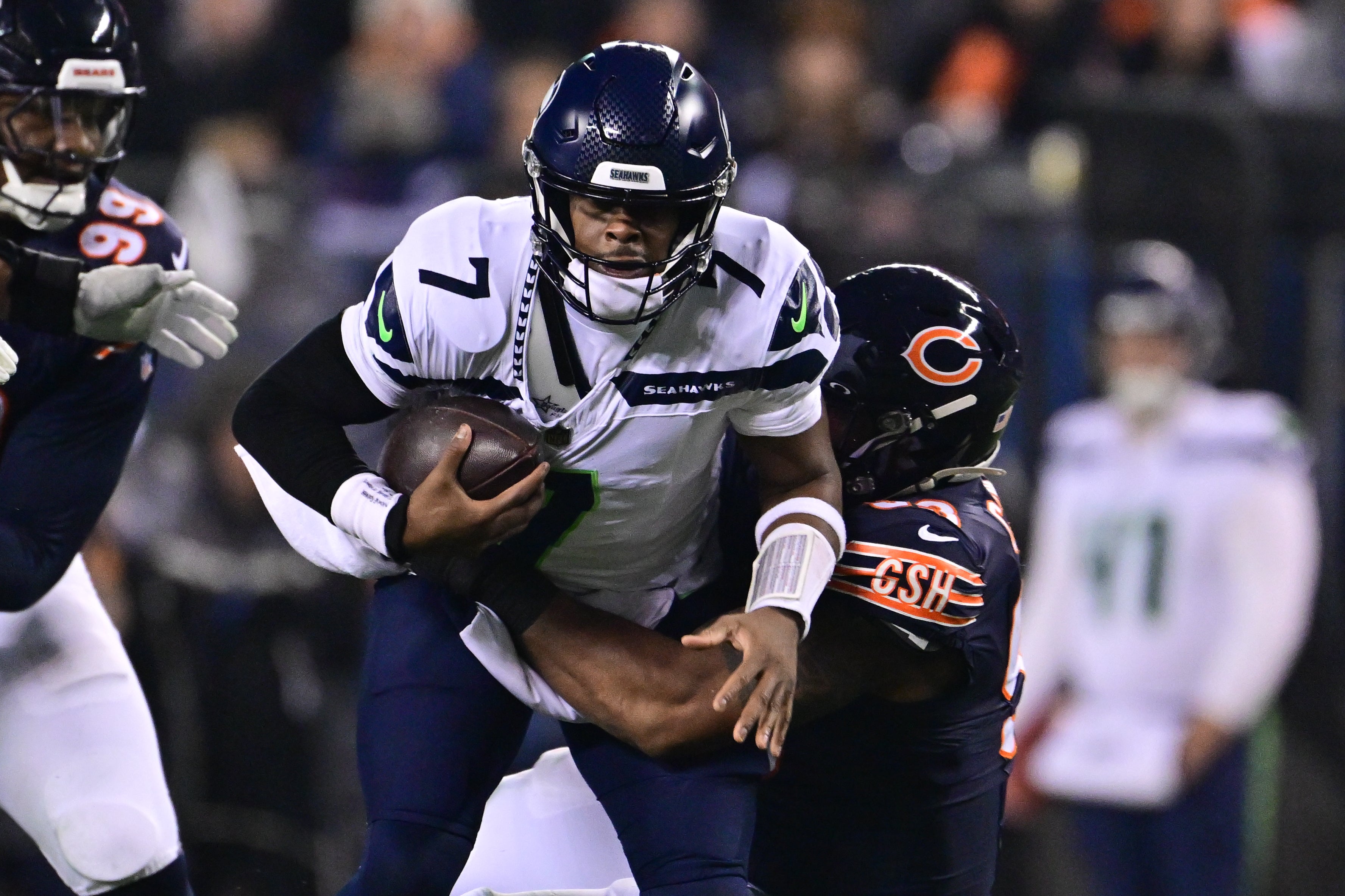 Dec 26, 2024; Chicago, Illinois, USA; Seattle Seahawks quarterback Geno Smith (7) is sacked by Chicago Bears defensive tackle Byron Cowart (93) during the second quarter at Soldier Field.