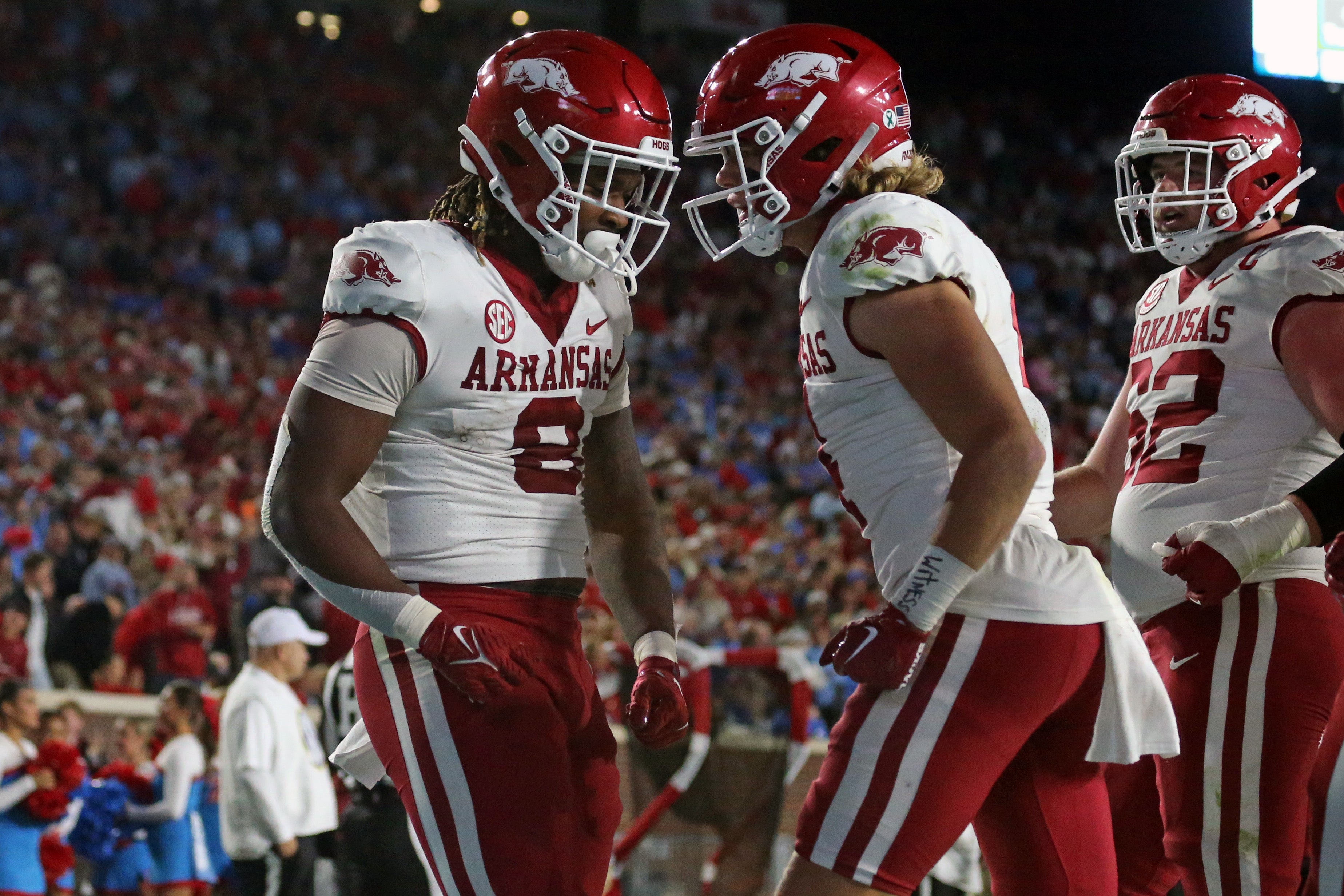 Arkansas Razorbacks tight end Ty Washington (8) reacts with wide receiver Isaac TeSlaa (4) after a touchdown during the second half against the Mississippi Rebels at Vaught-Hemingway Stadium.