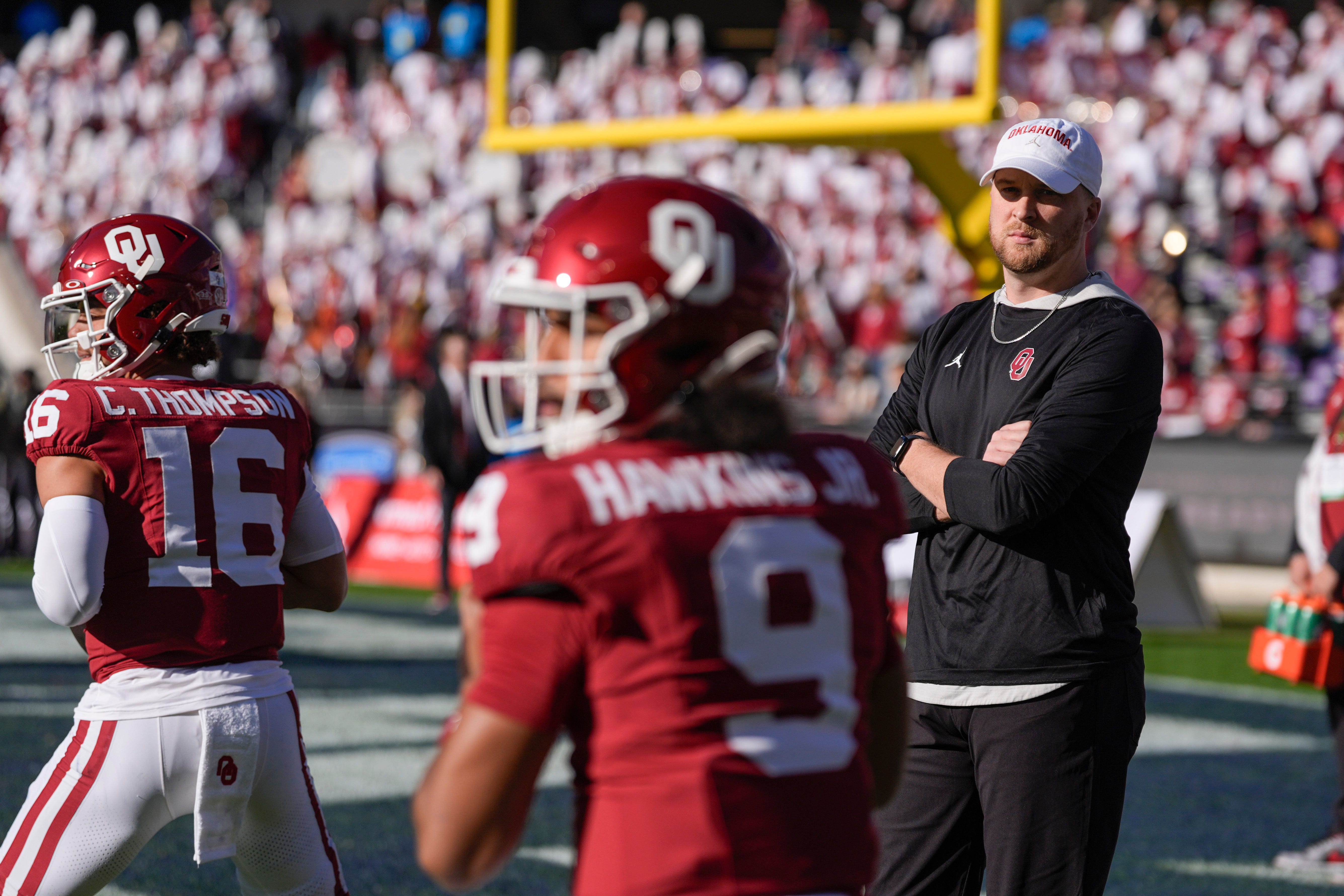 Ben Arbuckle watches Oklahoma Sooners quarterback Michael Hawkins Jr. (9) and Oklahoma Sooners quarterback Casey Thompson (16) before the Armed Forces Bowl football game between the University of Oklahoma Sooners (OU) and the Navy Midshipmen at Amon G. Carter Stadium in Fort Worth, Texas, Friday, Dec. 27, 2024. Navy won 21-20.