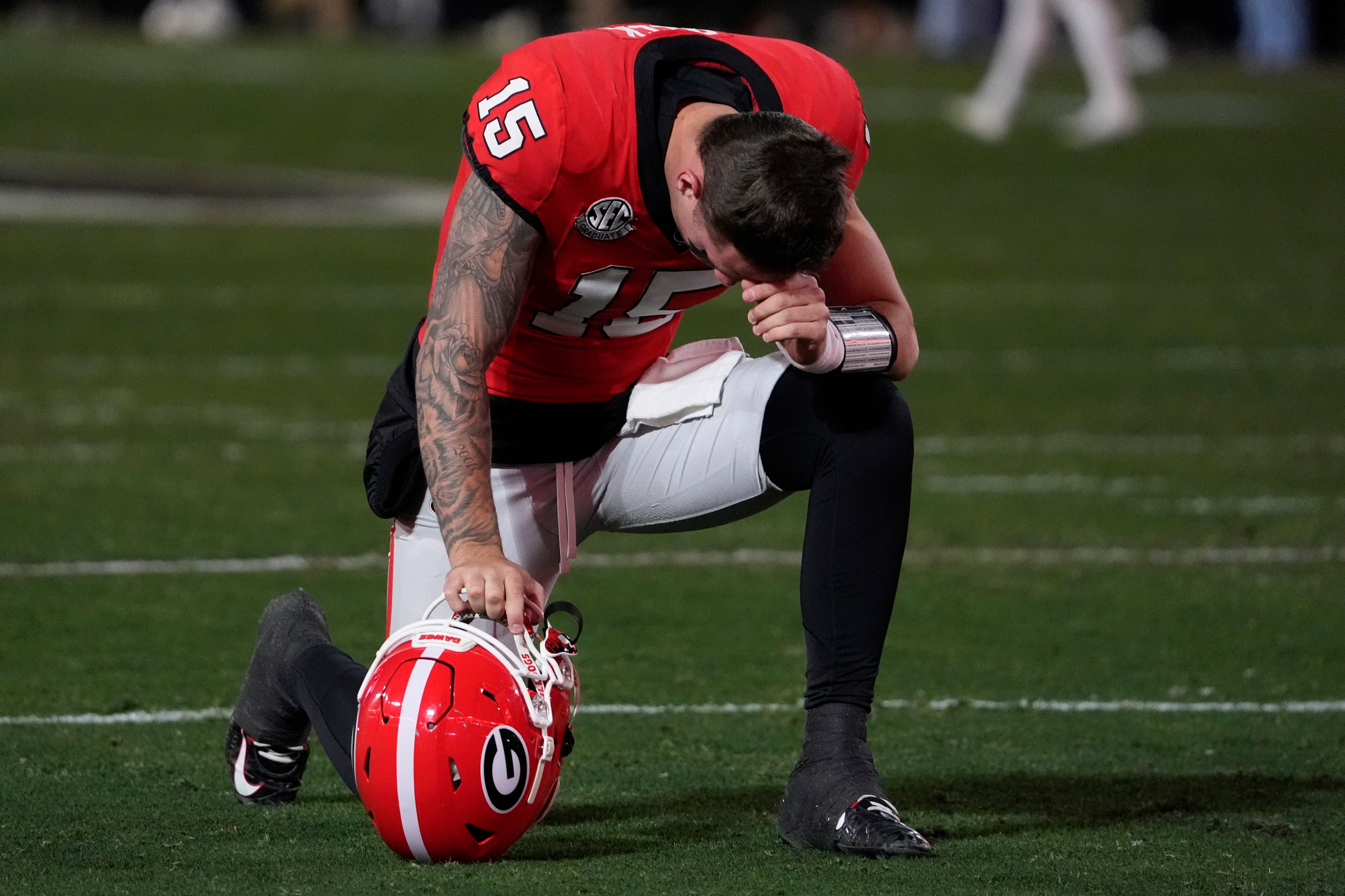 Georgia quarterback Carson Beck (15) prays before the start of the first half of a NCAA college football game against Georgia Tech in Athens, Ga., on Friday, Nov. 29, 2024.