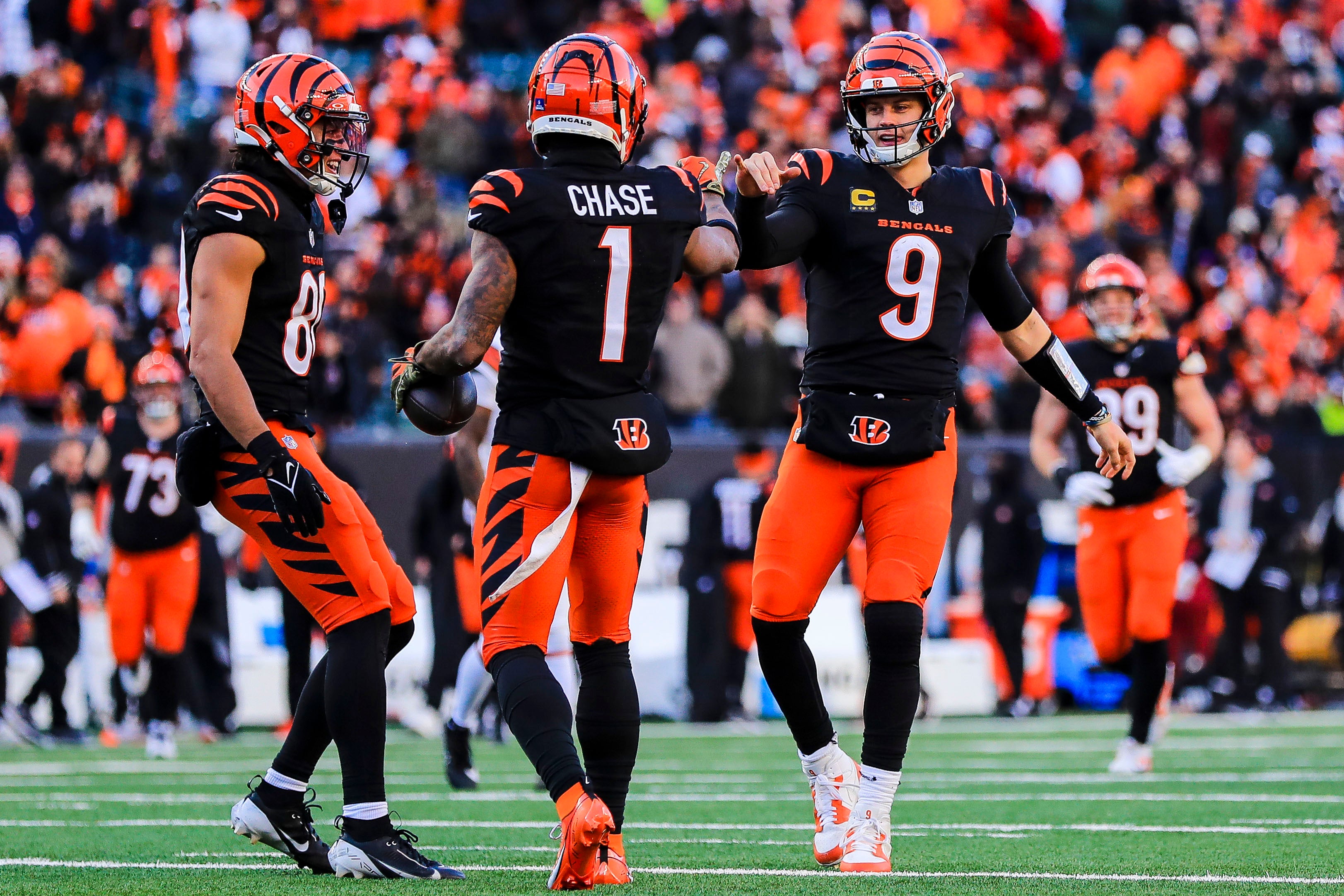 Dec 22, 2024; Cincinnati, Ohio, USA; Cincinnati Bengals wide receiver Ja'Marr Chase (1) reacts with quarterback Joe Burrow (9) after scoring a touchdown in the second half against the Cleveland Browns at Paycor Stadium.