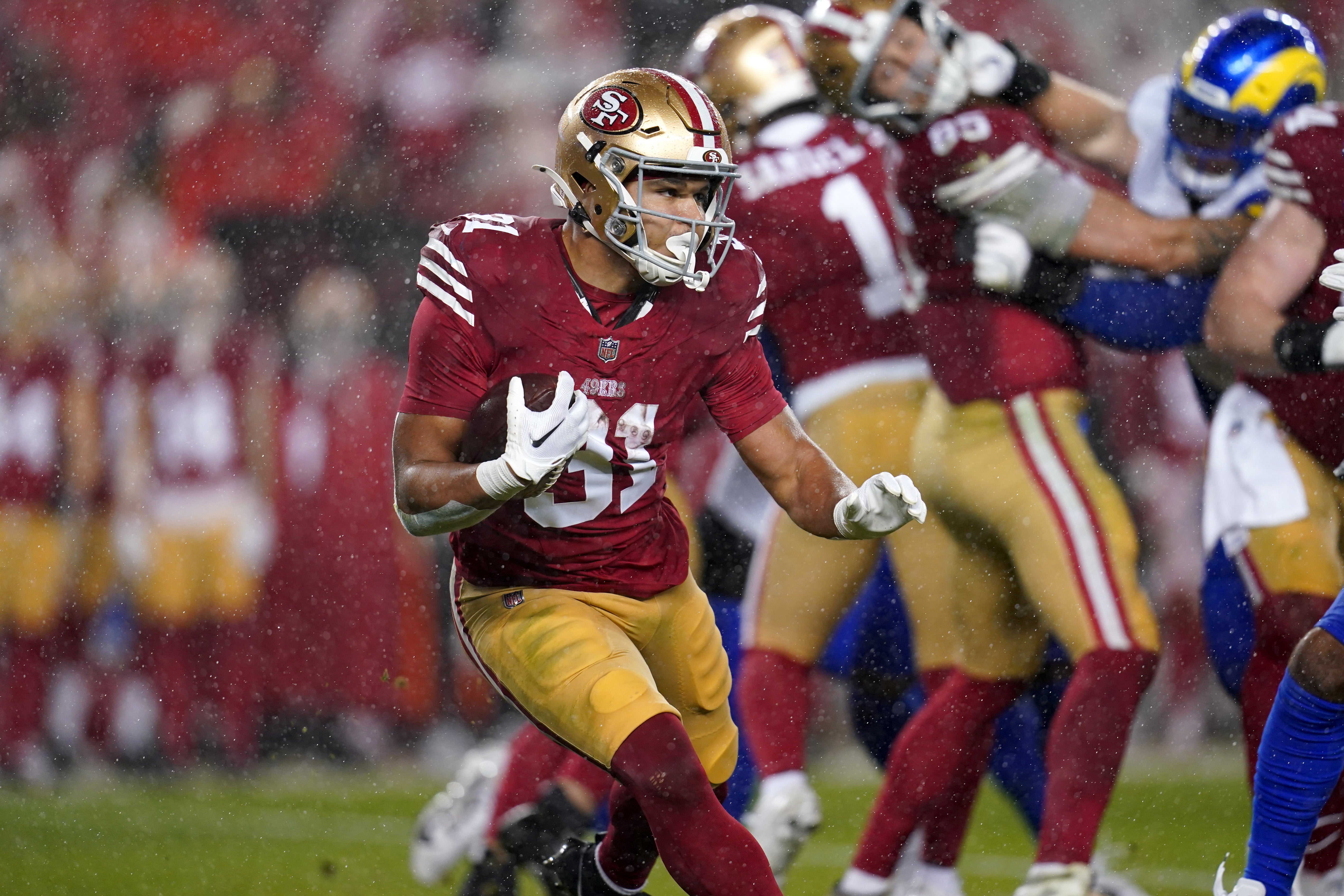 San Francisco 49ers running back Isaac Guerendo (31) runs the ball against the Los Angeles Rams in the second quarter at Levi's Stadium.